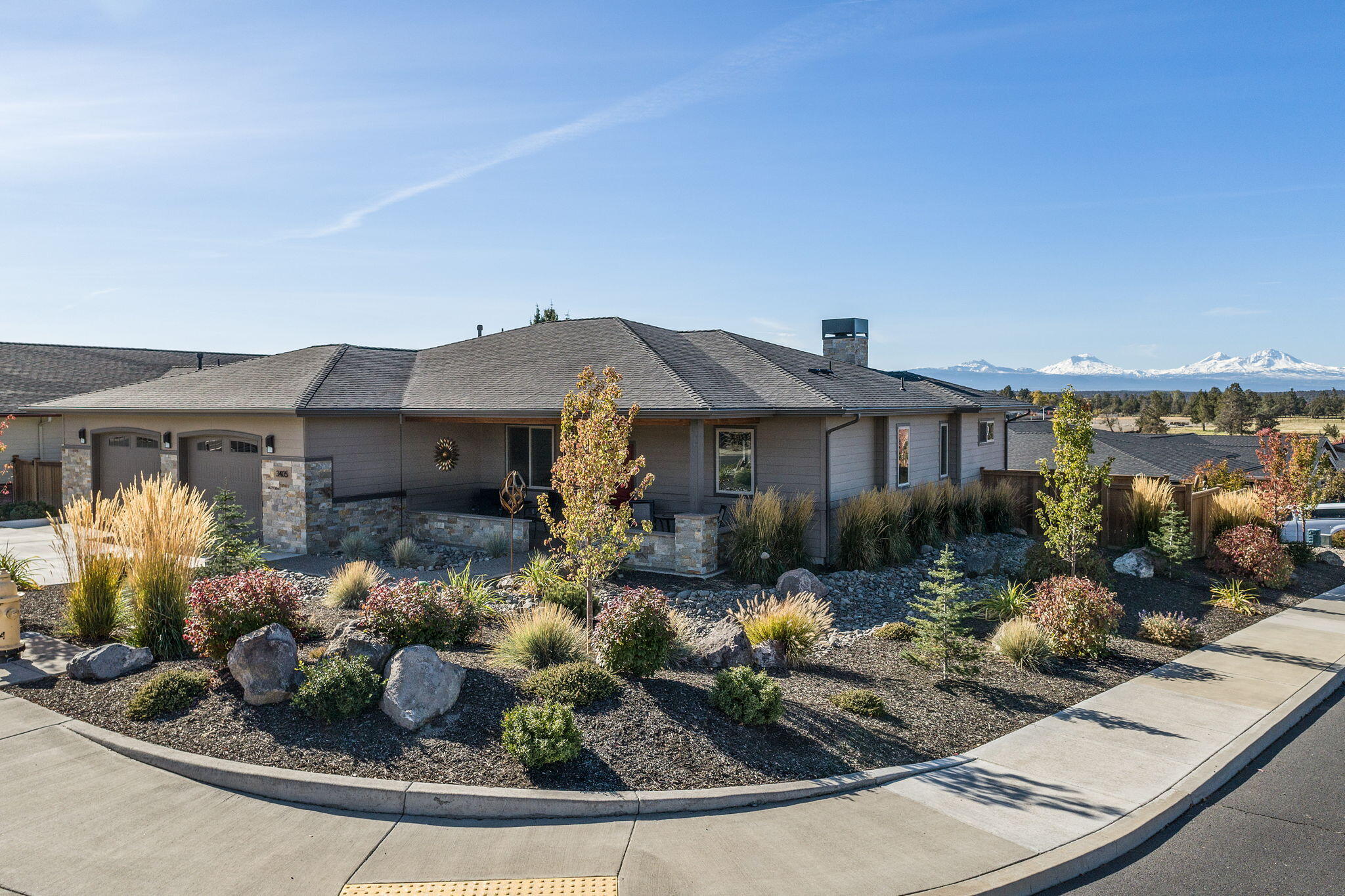 Located in the exclusive Forked Horn Butte area, this elegant home has it all! On a large corner lot with panoramic views of the Cascade Mtns from Mt Bachelor to Mt Jefferson, it has a Gold EarthAdvantage certification,Xeriscape landscaping and the most perfect one level floor plan you'll ever live in.The elevated back paver patio faces the view, has sun protection and the warmth of a gas fireplace so you can enjoy it all year long. The kitchen has quartz counters, tons of storage and prep space, a butler's pantry, a walk-in pantry, a gas range, stainless steel appliances, cool tile -and WOW views. The Copper Ledge stone fireplace and bar nook in the great room create a warm ambiance and the colors are serene. Newly built, pls,see attached 4 page list of upgrades: a 2stage furnace, appliances, gas fireplace, carpet, closets, garage doors, lighting, sun shades. The cost of living and slow pace of life are a big bonus to living in Redmond. 10 minutes to the airport.  Please visit soon!