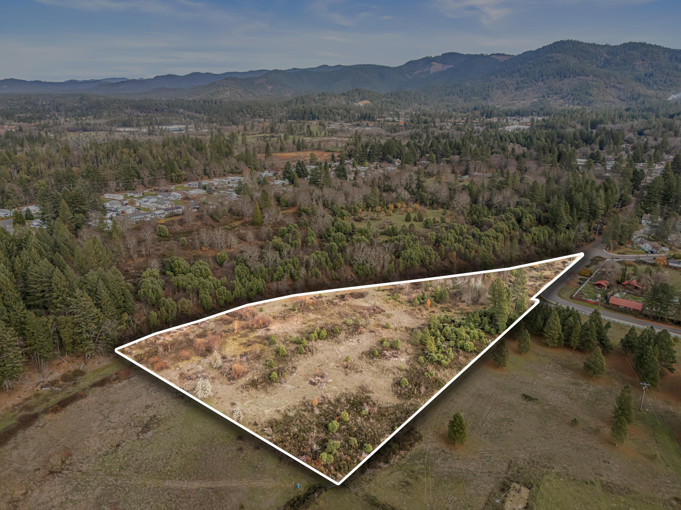 Attention developers!! If you're seeking a high density (SR zoning) parcel mins away from Downtown Cave Junction, this is the one for you! This 6+ acre wooded & leveled property features easy access throughout the year with amazing views of the mountainside. City water and city sewer are obtainable. Buyer to perform their own due diligence pertaining to the possibilities of building and permitted uses. Perfect opportunity for anyone looking to develop a subdivision and/or build their dream home in a private setting close to town, so contact your agent today for a personal tour, before it's too late!