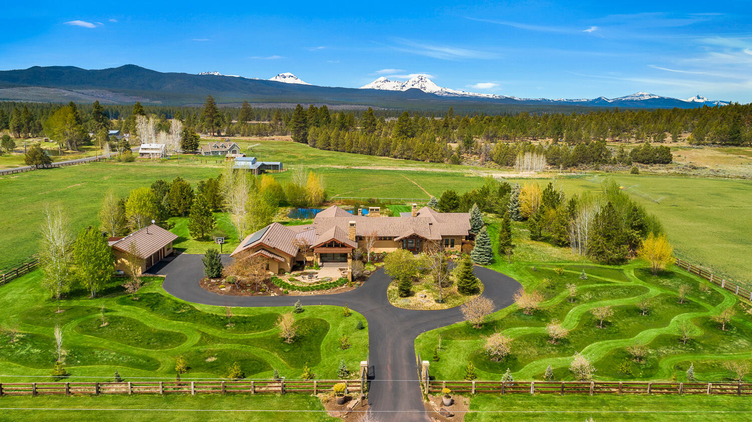Absolutely stunning West Tumalo gated estate encompasses 11+ acres of majestic Cascade Mtn views located steps away from the Deschutes Nat. Forest & Tumalo Reservoir trail system w/ miles of running, bike & horse trails. Minutes to Bend, this is truly a spectacular property with every upgrade imaginable in this 5614 sf single-level high efficiency passive solar designed home. Enter to framed mountain views through immense glass door. Gourmet kitchen doesn't begin to describe it; the love of entertaining is a requirement. Memories will be made & shared by wood burning fire. North & south bedroom wings flank courtyard. Stroll the grounds complete with pasture, orchard, trees for privacy, pond w/ bridge & waterfall. Fully fenced & cross-fenced 10.19 acres of auto WIFI irrigation plus barn. Attached 3-car and detached 2-car heated garages, detached studio/workshop, garden beds, solarium greenhouse, in-ground spa & outdoor kitchen. We invite you to see for yourself what words can't describe