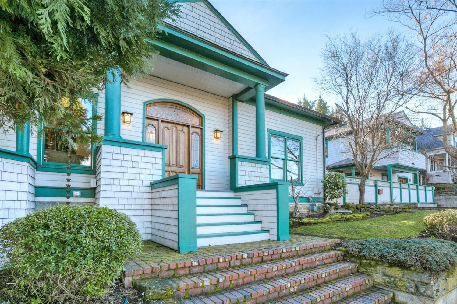 Exceptional opportunity to own the historic 'Alice Foster House' with fully renovated detached ARU permitted for Traveler's Accommodations, located directly across from the Ashland Library! Main residence on Gresham Street with charming wrap-around covered porch, original solid fir floors, built-ins with leaded glass display cabinets, wood-wrapped windows, spacious living room, formal and informal dining areas, kitchen with butcher block island, walk-in pantry, half-bath, three main-level bedrooms with full bathroom, and a wide stairwell to two upper-level bedrooms with additional full bathroom. Detached ARU on Hargadine Street rebuilt in 2014 with a complete kitchen, alder cabinetry with glass displays, solid oak flooring, skylight, full bathroom, French doors to private covered view balcony, plus a tiled main-level studio or bedroom and additional full bathroom and laundry room. Fully fenced private brick courtyard and three off-street parking spaces. Inquire for details!