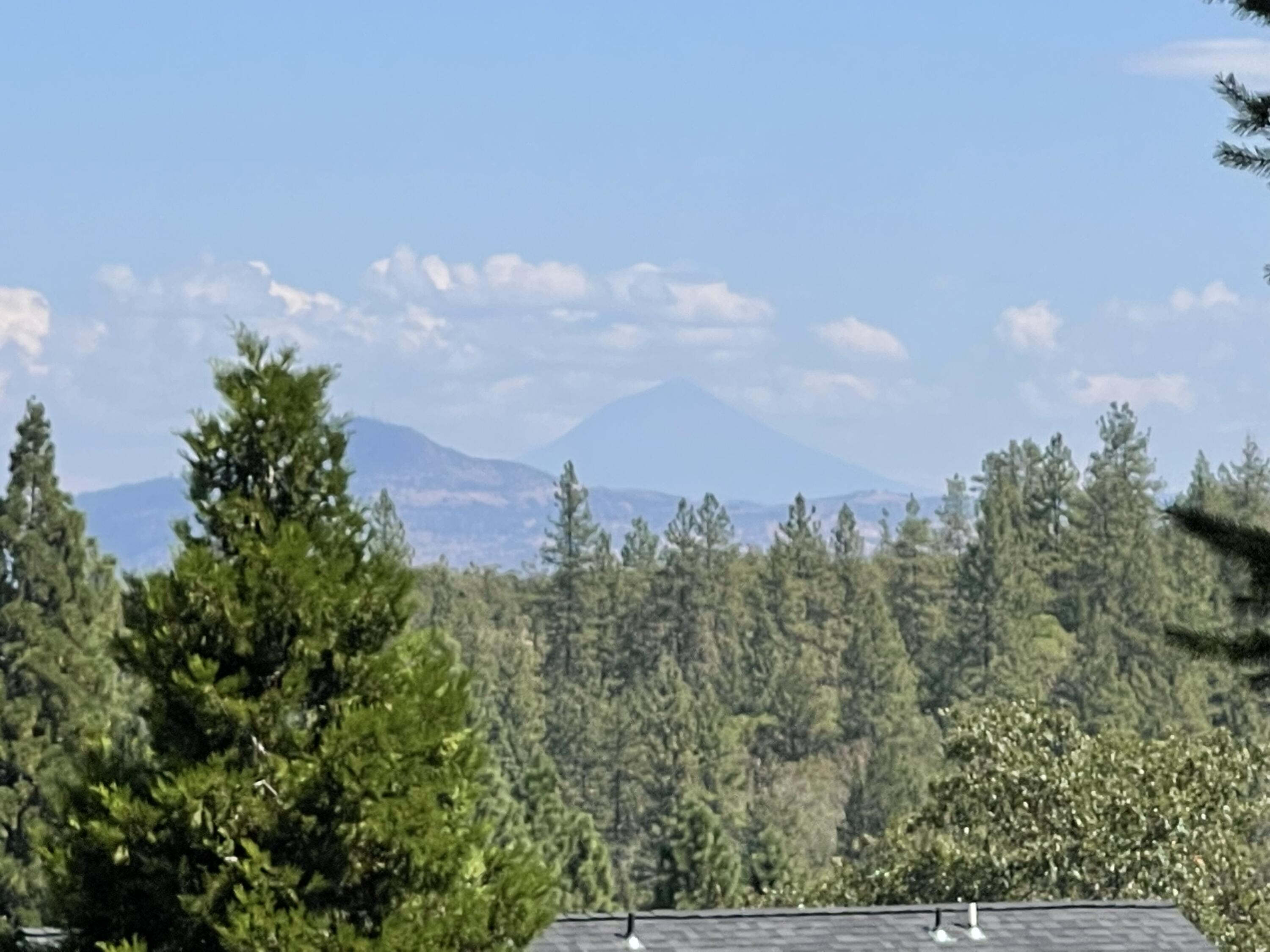 Rare opportunity just minutes from historic downtown Jacksonville! Granite Ridge offers sweeping views of the valley, Mt. McLoughlin, and sparkling city lights. This exclusive subdivision backs up to the Woodlands Trails, with over 13 miles of hiking right outside your door. The spacious .42-acre lot comes with full city services, including gas and cable. Just a half mile from the Britt Festival and downtown Jacksonville, you'll enjoy easy access to live music, boutique shopping, and top dining. With only 9 total lots in Granite Ridge, this quiet and private setting is the perfect place to bring your builder and create your dream home. Properties like this are rarely available—don't miss your chance! Build to suit option available. Please call for more details.