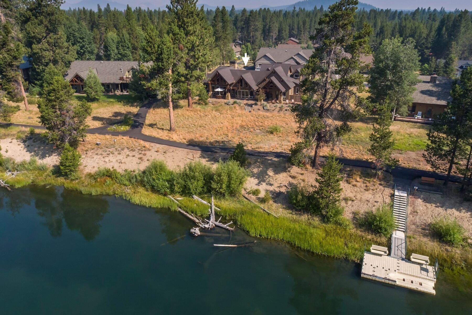 Alight on a gentle curve of the Deschutes river, this inviting mountain retreat is where memories are created and seeds of nostalgia are sown. Here, modern lodge styling, exceptional build quality and a smart layout give way to charming natural elements: timber beams, a large stone hearth and wood-burning fireplace, an upstairs observation nook, and Deschutes River views from nearly every room. The well-designed kitchen boasts luxury modern appliances and tasteful finishes such as raw-edge granite countertops. A fully equipped adjacent butler pantry makes meal preparation a breeze. Four comfortable bedrooms offer a peaceful sanctuary to rest and recharge. The finished, EV-enabled 3 car garage leaves room for outdoor gear and indoor toys without sacrificing comfort in the winter. Any season of the year, enjoy recreating on the river: fly-fishing, floating with a cold drink or enjoying a morning paddle. The joys abound with a home so supremely situated for relaxation and adventure alike