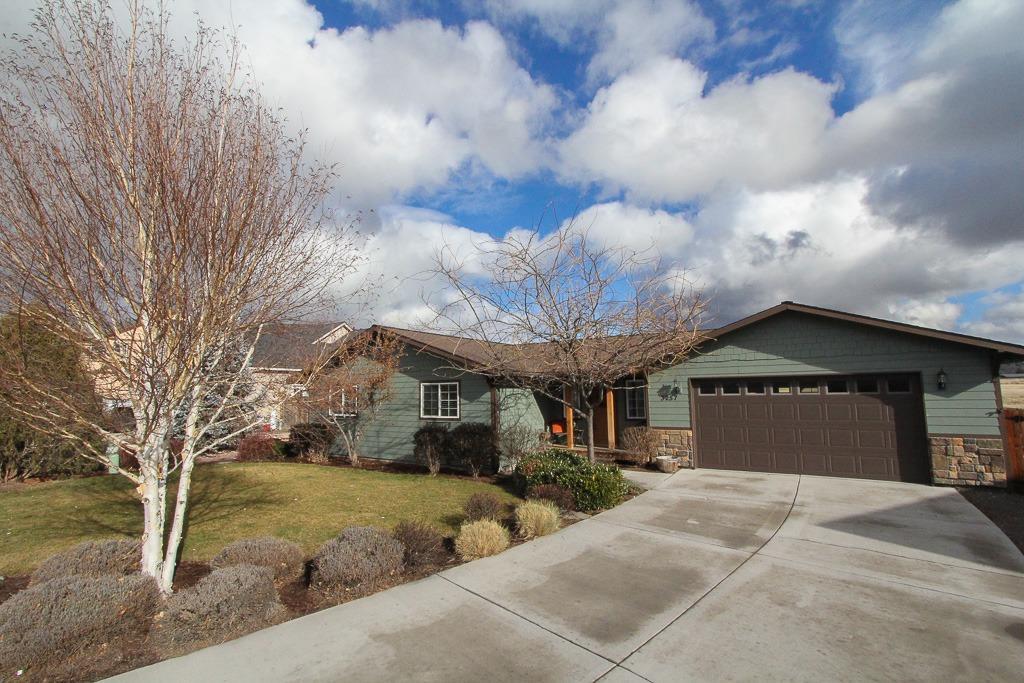 Custom built single story home in 2005 on spacious lot in Klamath Meadows East. 3 bedroom 2 bath rancher has no neighbors behind, and fully fenced backyard. Covered porch leads to functional entry with closet. Open floor plan has separate dining, kitchen with Corian counter, Craftsman cabinets and garden window plus vaulted great room. Cherry colored oak floors. Master features walk in closet, Corian counters and double shower head. Laundry room with counter and cabinets. 2 12 X 12 bedrooms and additional bathroom with tub/shower combination. Beautiful backyard has fenced dog run, chicken coop with pen, greenhouse, fenced garden area, covered patio and adjacent deck. Graveled RV parking. This is a lovely home.