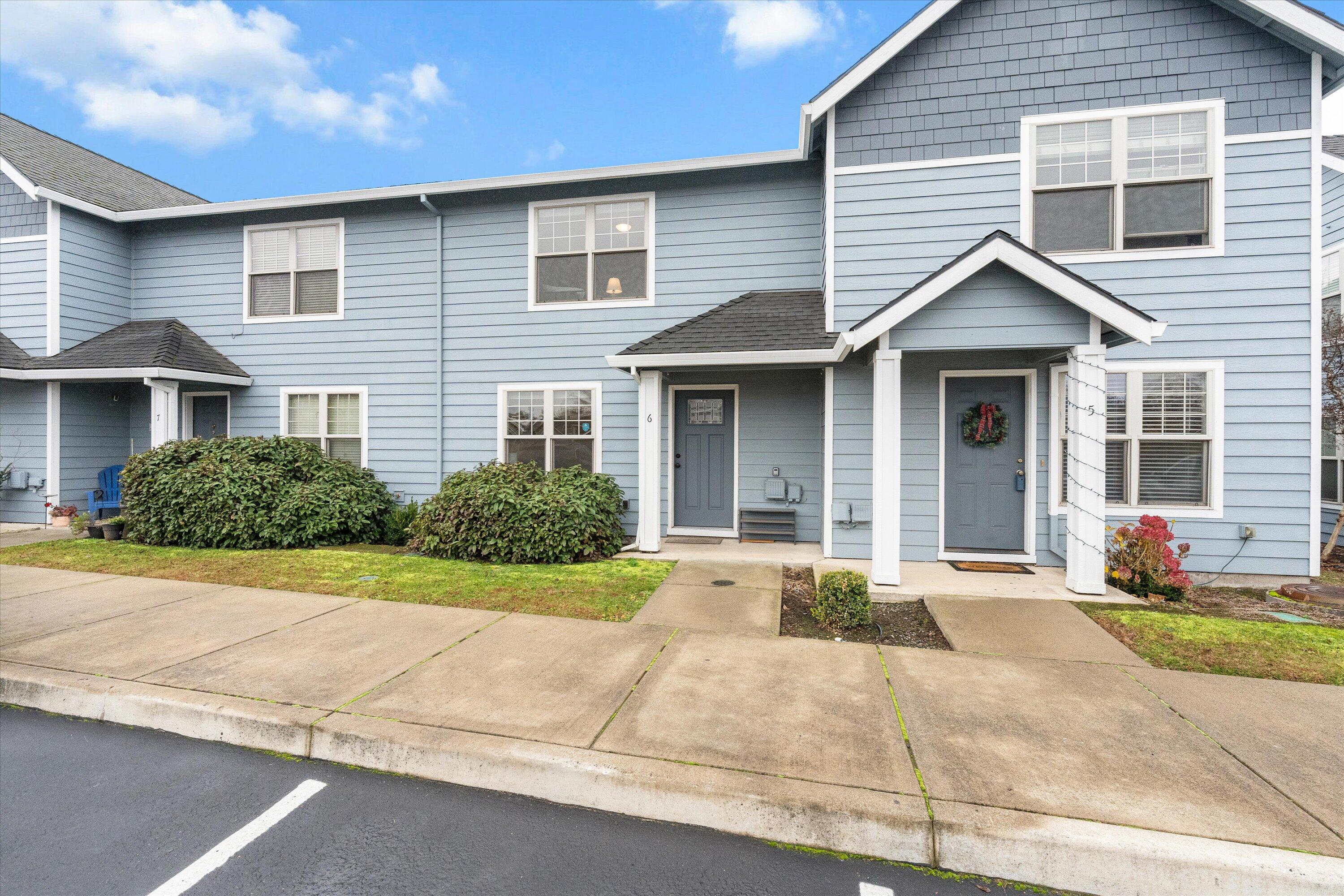 This townhome style condominium was newly renovated in 2022 with new floors, appliances, updated cabinets, lights, paint etc. Centrally located near many amenities like the Rogue Valley Mall, Costco, Target, Trader Joes, Chick-Fil-A and so much more. The 1280 square foot floor plan offers 3 bedrooms and 2 bathrooms with a well appointed kitchen and main level laundry area. The common areas including the living room, dining room and kitchen are all located on the main level while the bedrooms and full bathroom can be found upstairs. This home offers nice big windows that let in lots of natural light. Out back you'll find a cute cozy patio in the private backyard with a good sized storage room off the patio.