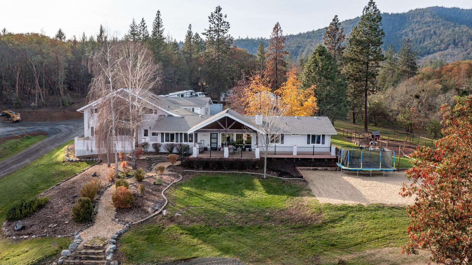 Beautiful home on 22+ acres with a country feel and less than 1-mile from historic Jacksonville. This two-story home features a large covered front porch with great mountain views, main level of living and an upstairs bonus room for a potential two-family setup or home office. This home was remodeled in 2019 and features an open floor plan, main floor master suite with private deck, split floor plan with all bedrooms on the main level. There is a lot of room for hobbies with an attached finished 2+ car garage with an extra room behind, a large finished detached shop with 220. The grounds are abundant with wildlife. Multiple deck/patio areas, a sand volleyball court, trails, chicken coop, fenced garden area and Jackson Creek. This would make a great horse property. Across from the Britt trailhead for access to miles of trails.