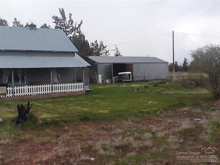 Excellent Powell Butte location, with irrigated and fenced pasture. Large shop with storage loft and room.