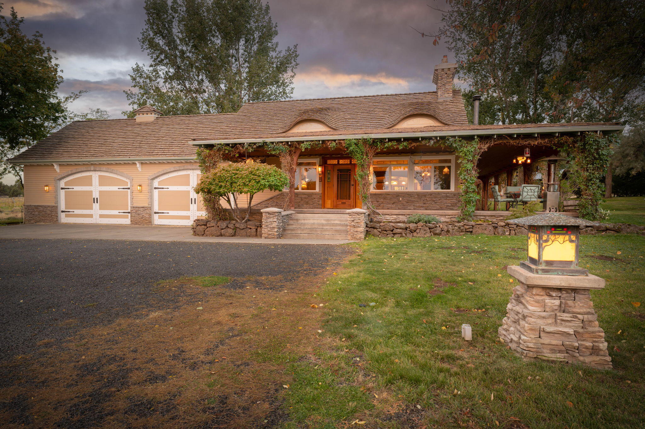 Stunning master craftsman Green & Green inspired farmhouse on 38 acres with 23 acres of irrigation & large shop. Drive over canal rapids, under old growth fruit trees, past a pond with waterfalls, gazebo and expansive landscaped yards. Exquisitely detailed 3,092 sqft, 4 BD+ (bonus room), 2.5 BTH home features a Great room w/vaulted ceilings, walls of windows overlooking the ranch, floor-to ceiling fireplace and custom wood built-ins. Chef's kitchen with island, breakfast bar, granite countertops, solid wood floors, cabinets, dining area and built-ins. Spacious porch w/gas grill for entertaining. Main level primary suite offers a spa-like bath w/dual vanity, rain shower, travertine tile, heated floors and walk-in closet. Oversized 4 car garage w/storage loft, & large, heated shop w/2nd level storage. One-of-a-kind property with two ponds, canal frontage, orchards, green house & pasture. Come tour this beautiful home today! Listing Agent is related to the Sellers.