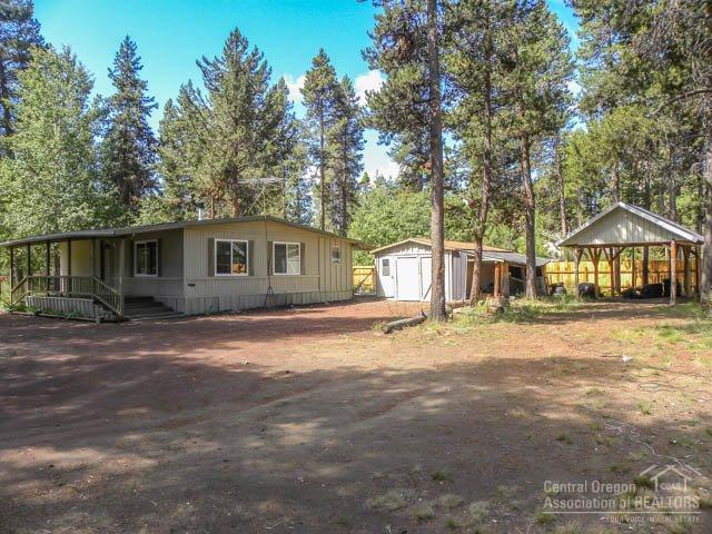 1 Acre private corner lot on well-maintained road with easy access to all things outdoors. Home has Fresh paint, vinyl windows, metal roof, covered porch, newer wood stove and electric forced air. All appliances included to help make this a move in ready, affordable home for first time buyer or investor. Exterior features include fenced back yard, single car garage plus carport RV, or other recreational toys.