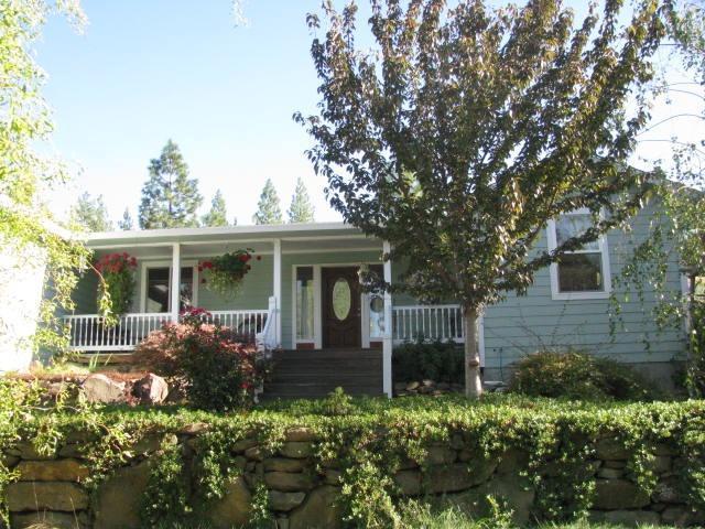 Private country setting! Wonderful home with a light and open great room floor plan. Large kitchen with granite, stainless appliances, douglas fir cabinets, skylights and more. Master has vaulted ceilings, skylight and bath with granite and jetted tub. Living area has beautiful red fir floors with vaulted ceilings giving it a very open feel. Well-built home has covered front porch, 400 sqft deck, hardie plank lap siding and dual fuel HVAC. Property has mature trees, water feature, good well, 24' X 28' shop, nice views and room for vehicles & equipment.