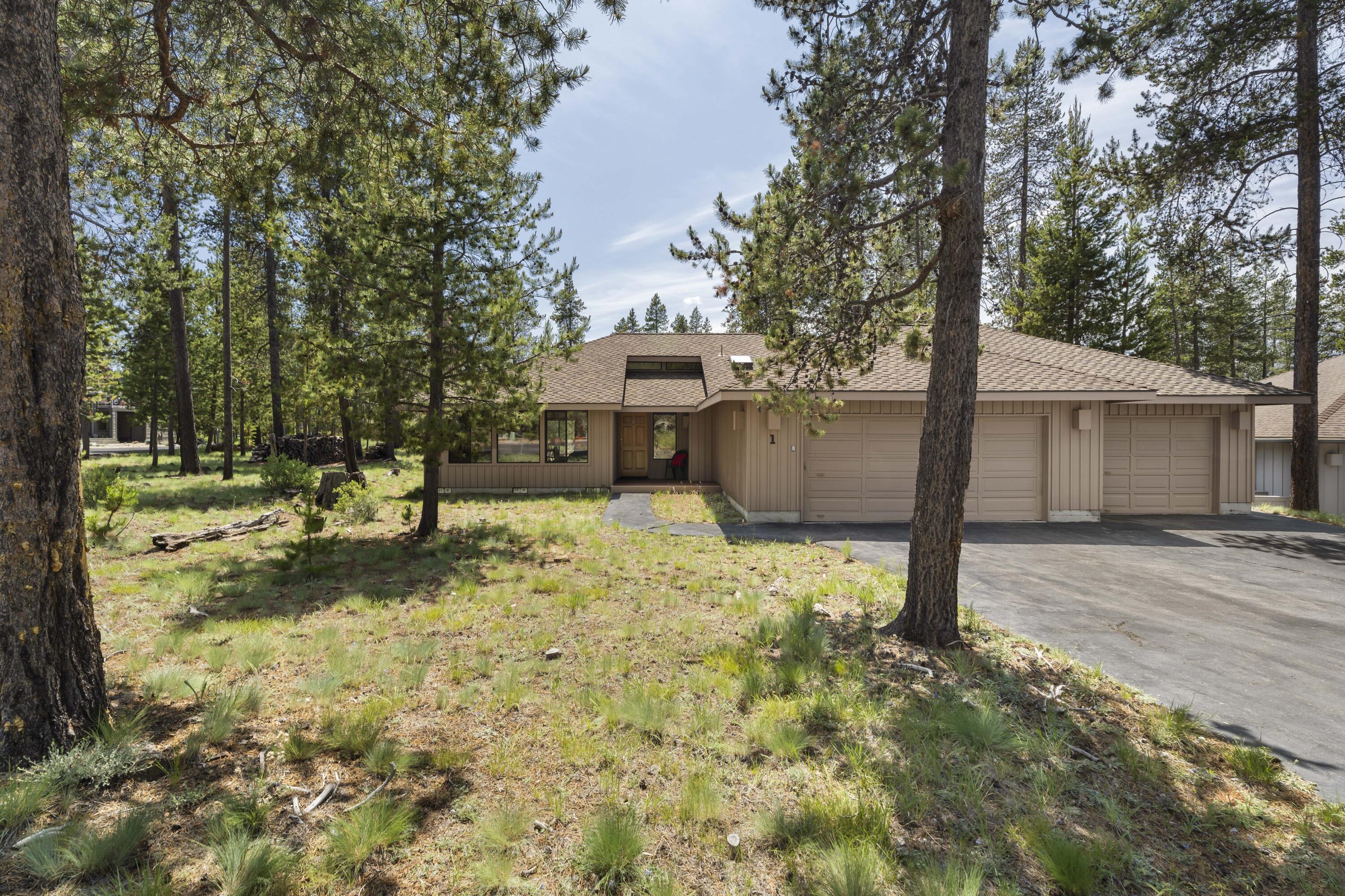 Welcome to your Sunriver getaway! This single-level, 3-bedroom, 2-bath home offers an open, vaulted floor plan filled with natural light from expansive windows. The generous great room is perfect for gathering, complete with a cozy wood-burning fireplace to warm chilly evenings. With nearly 1,500 sq. ft. of comfortable living space and a rare 3-car garage—uncommon for homes this size—you'll have room for all your gear and toys. Each bedroom and the main living area feature sliding doors that open to the spacious deck, creating seamless indoor-outdoor living. The large deck includes an enclosed hot tub—an ideal spot for relaxing and taking in the beauty of nature and local wildlife. Backing to a spacious common area, and with easy access to the north end of Sunriver, including the Cottonwood entrance, new dog park, and nearby amenities. Sold fully furnished with SHARC paid, this home is ready for your personal touch. Start making memories in Sunriver today!