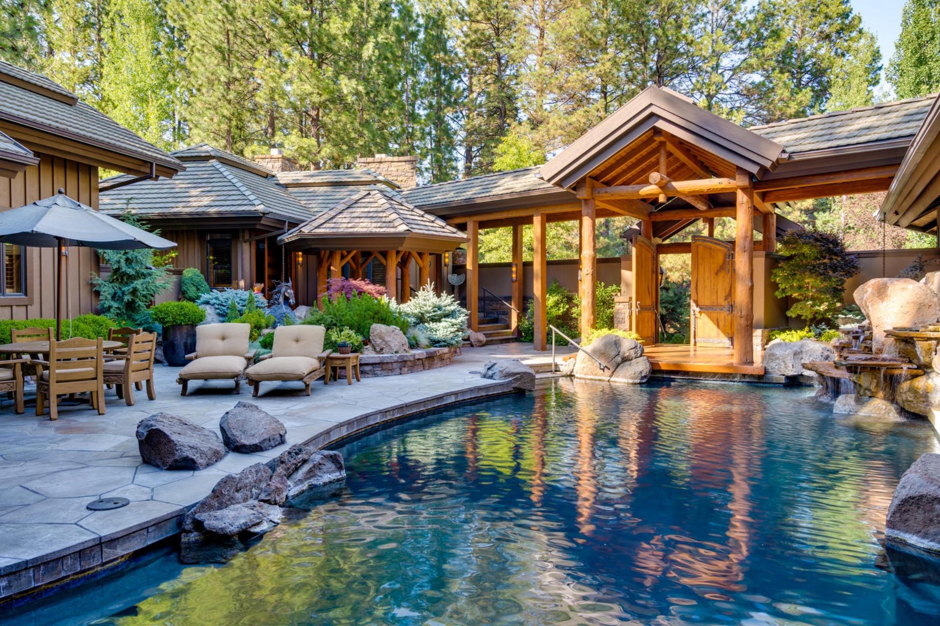 WELCOME TO CASA MONTANA
This Broken Top beauty is situated on the premiere, Weiskopf golf course in Bend, Oregon. Upon entering the doors of Casa Montana, you are greeted by a private courtyard with a serene pool, a flowing water feature, and an outdoor spa. The tranquil, poolside patio offers the perfect space for lounging or entertaining your guests. Combining stately spaciousness with cozy elegance, this spectacular home offers 5 master suite bedrooms, 5.5 baths, and 8 fireplaces. With high ceilings and wood beams, this gorgeous residence is offered turnkey including furnishings and art - right down to the silverware. Overlooking the courtyard is a separate, 1,000 sq. ft. guest residence and gym tucked away just steps from the pool and spa. With lush landscaping, harmonious garden sculpture, and a large, terraced outdoor deck overlooking the golf course, Casa Montana is a must-see property.