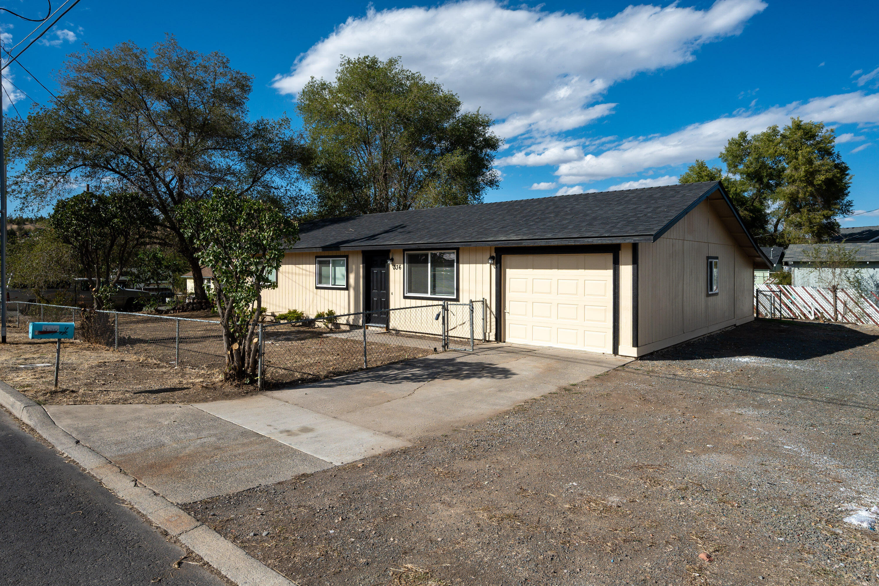 Nicer than new single level ranch style home with a great room layout on a large corner lot with RV parking. The entire structure has been fixed and retouched; the roof, exterior paint, interior paint, cabinets, appliances, water heater, fixtures, counters, and floors are all brand new. Once inside the front door you are greeted by a great room layout with excellent natural lighting. Luxury vinyl plank flooring is installed throughout. Granite counters, custom black cabinets, a single bay sink, ample lighting, and very nice stainless appliances highlight the great room space. The primary bedroom connects to the large single bathroom with brand quartz counter vanity, toilet, and shower. Both guest bedrooms are nicely sized and on the opposite side of the home from the primary. The attached single garage is oversized and fully insulated. Outside you'll find an attached storage shed, a fenced yard, and a covered back patio!