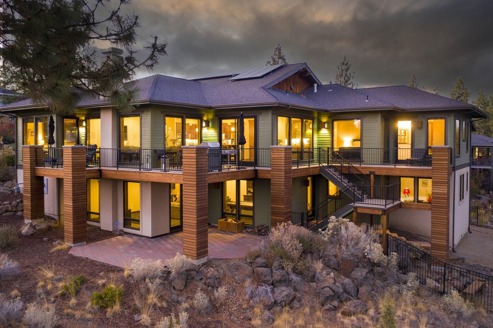 Tucked gracefully on the hillside in a quiet cul-de-sac in Shevlin Ridge, this custom home is at once captivating and contemporary. Rich wood accents flow through the home, lending to a warm yet sophisticated aesthetic. The open floorplan was built for entertaining, and the extensive deck is a haven for outside gatherings or for enjoying your coffee while taking in the forest views. Inside, the chef's kitchen boasts high-end appliances and a beautiful island with a wood breakfast bar. The main-level primary bedroom features its own private deck access & large bathroom w/ double vanities, jetted tub, & beautiful tile walk-in shower. Also on the main level, find a den/office and sunny great room. Two additional bedrooms and bathrooms are downstairs, as well as a large family room with wood stove and wet bar. This stunning Earth Advantage home features rooftop solar and radiant heat flooring, as well as a fenced yard and an incredible 1280 sqft garage. Close to Shevlin Park and schools!