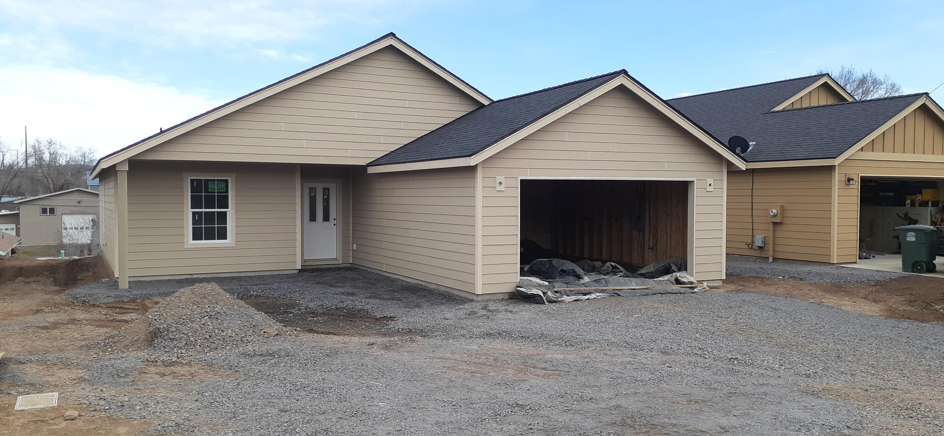 Now under construction, single level home.  1402 Sq Ft, 3 Bedroom, 2 Baths with large open kitchen and living room area. Kitchen island seperates the space with lots of kitchen cabinets. Good size primary bedroom with walk-in closet and bath.  Seperate utility room with lots of storage. Heat pump for heating and cooling. Sheetrocked garage. Convenient west side location.  Still time to pick colors for counter tops and paint! Projected completion by June.
