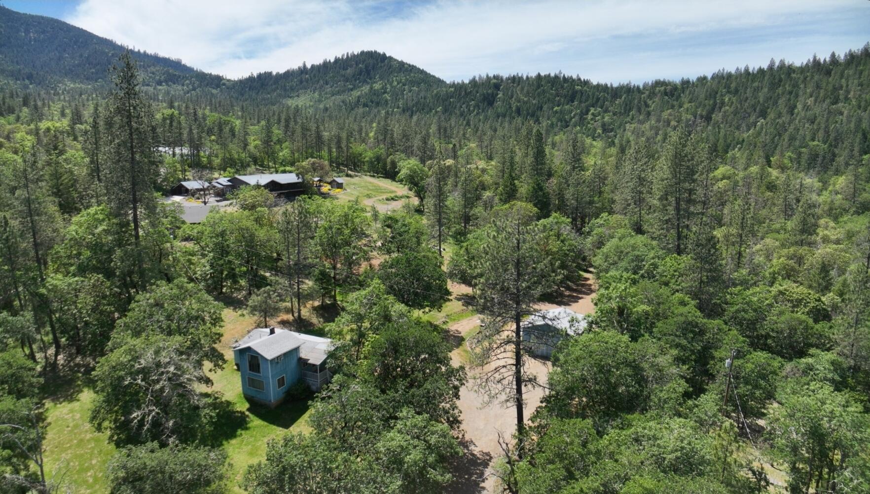 What a deal! Over 5 acres of land, house, shop and room to grow!  This estate is being sold as-is but if you have the time to customize and beautify this one, you have that rural home you have been looking for!  3 beds 1.5 bath home, shop is on concrete slab and doors open, room behind for storage on lean too and lots of usable land.  Nestled minutes from Murphy store and 12 mins to Grants Pass.  Hurry on this one! Cash or Conventional buyers only.  All information deemed accurate but not guaranteed and subject to change at anytime.