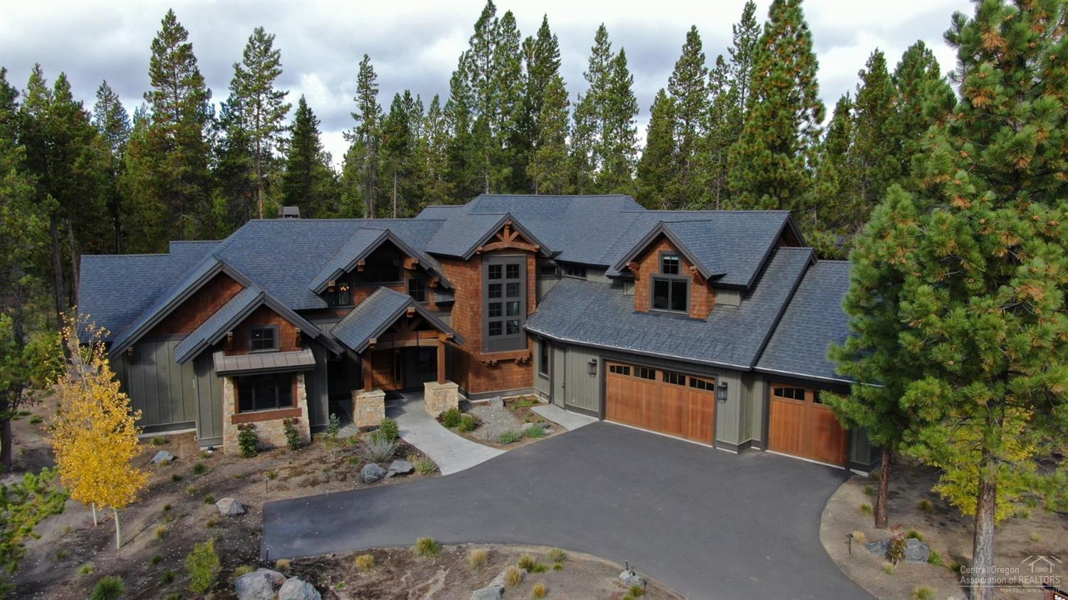 Rustic/Modern elegance in Caldera Springs! Beautiful Pineriver Homes built residence - 4,412 square feet of well-designed living space. 3 master suites downstairs, plus additional master suite, bunk room w/ built in bunk beds, and a bonus/game room upstairs. High end finishes include a gourmet kitchen, dining area w/ bar, vaulted wood ceilings in the great room and floor to ceiling stone/gas fireplace w/ built ins. Spacious mud/laundry room leads to a 3 car garage. .41 acre lot w/ wonderful outdoor space, paver patio, fire pit and sunken hot tub overlooking forested common area. This home is quality throughout. Start making memories in this custom Caldera home!