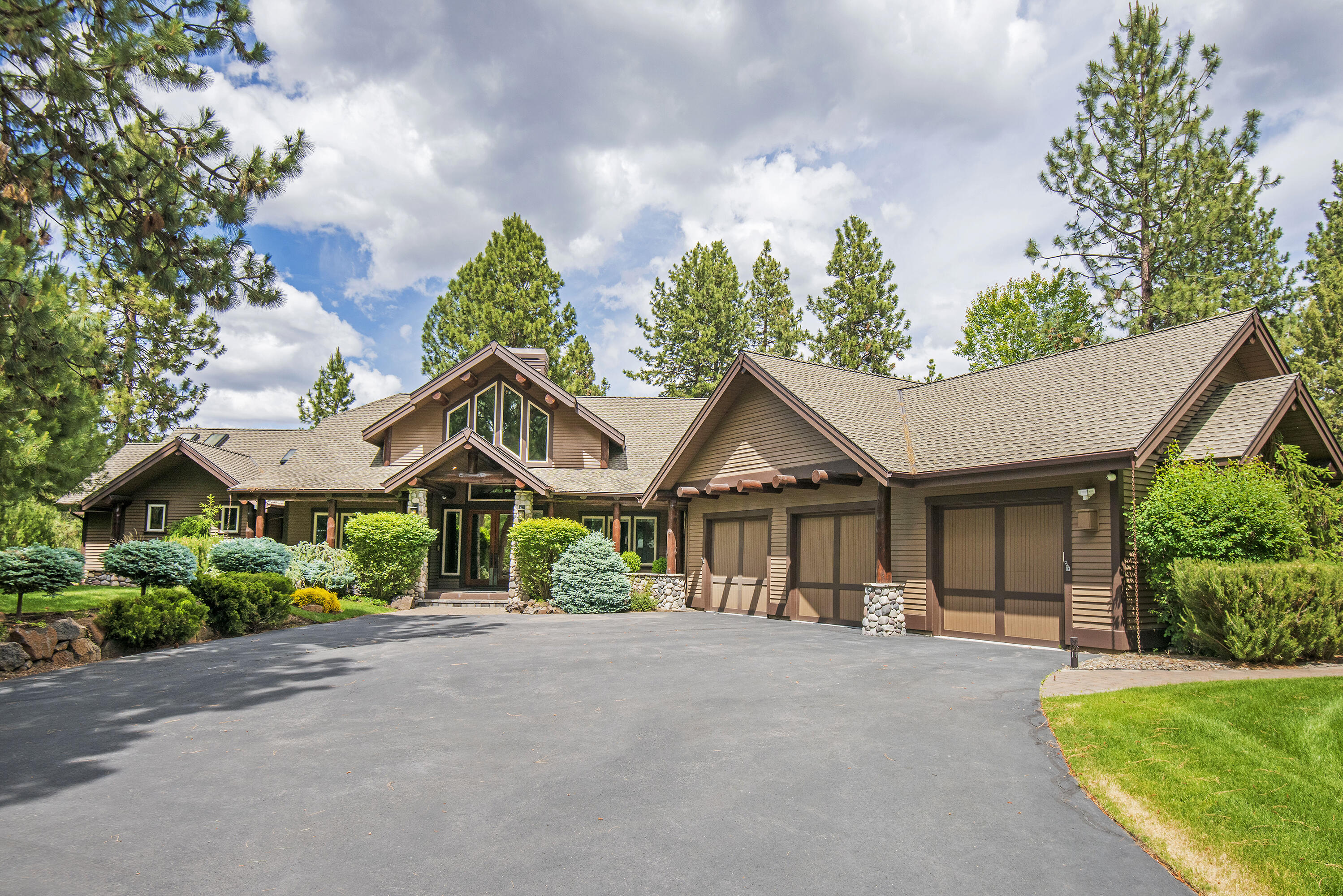 Original Sunset View Estate Lot, beautifully appointed single level home, huge RV barn/shop with additional hookups. Located on 2 1/2 acres, with exclusive access to adjacent 2 acres of common area for additional privacy. This home has it all, large kitchen island, top quality appliances, marble counters, knotty alder cabinets with soft close, new flooring, fresh paint, grand stone entry with double sided fireplace, timber accents, mahogany office, spacious primary bedroom with fireplace, 2nd primary has accessibility features, security system, super floor plan with triple car garage attached. The shop is magnificent, 14 ft overhead doors, 58 foot bay, 400 amp electrical service, heated, overhead fans, epoxy flooring, sink and laundry facilities, and private guest quarters; the grounds are meticulously maintained, mature landscape, pine trees, paved driveways, heated walkways, gazebo, water feature and a brand new pickle ball court! This property is a must see!!