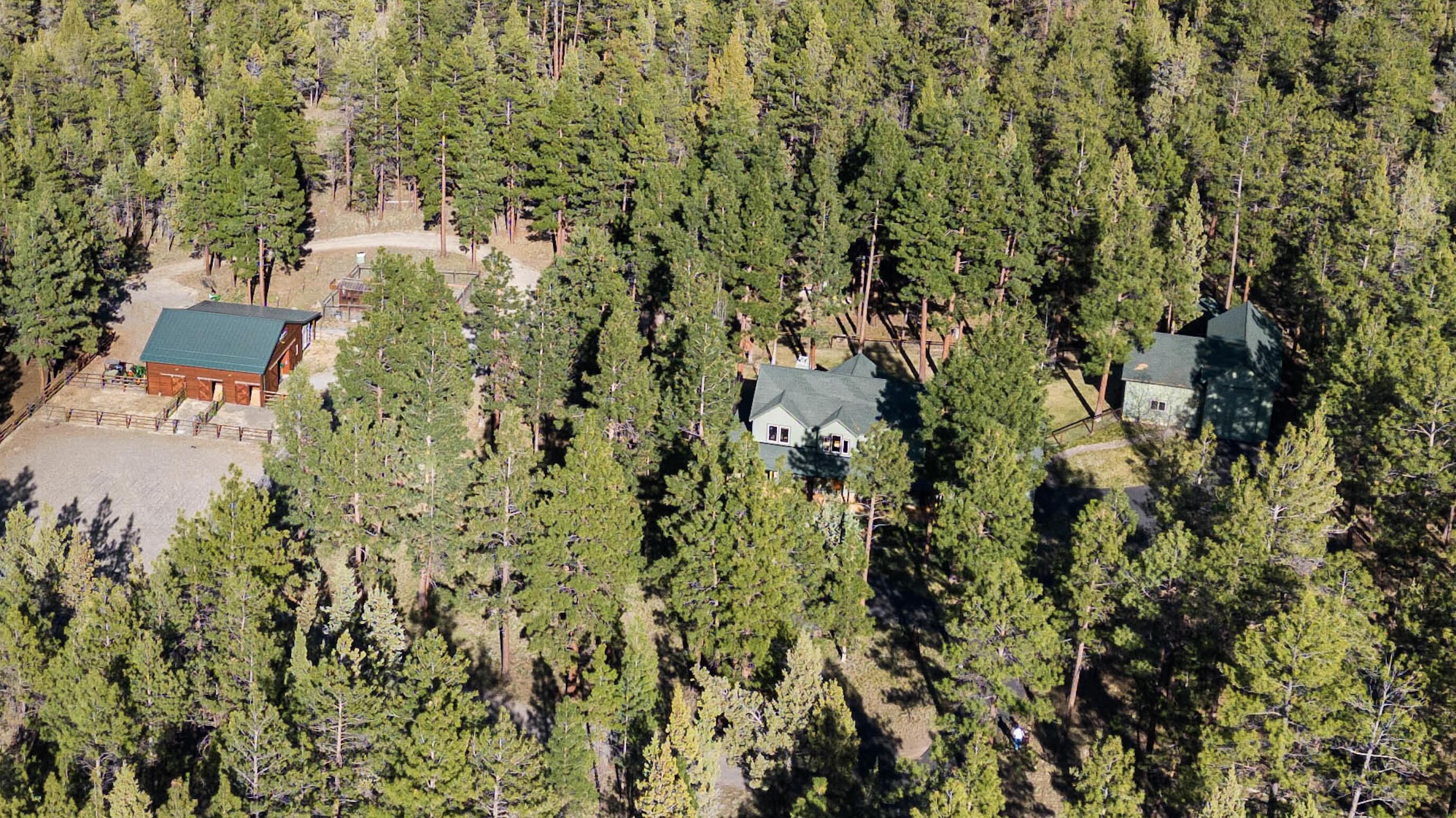 Very private acreage in one of Sisters' most desirable areas & only a few minutes to town. Includes: farmhouse, shop, barn, detached private room/office, chicken coop, greenhouse, raised garden beds. Home features: Hardwood floors; Vaulted ceiling/open loft; River Rock fireplace with built-ins; Open floor plan; Remodeled kitchen; Large laundry/mudroom; Primary bedroom with deck access to hot tub; 2 walk-in closets, walk-in shower, soaking tub; Large office/bedroom; Large bonus room; Newer HVAC and 2 hot water heaters; Covered wrap around deck with trellis in back; Fully fenced in yard for dogs. 1200sf shop with 16' door and additional pass through door. 1296 square foot barn in a picturesque dugout setting features 3-stalls, turnouts, insulated tack room, hay storage, covered parking area, corral, round pen, fenced paddocks, and loafing shed. Property features extensive landscaping including a stream and access to 160 acres of public lands for riding and hiking.