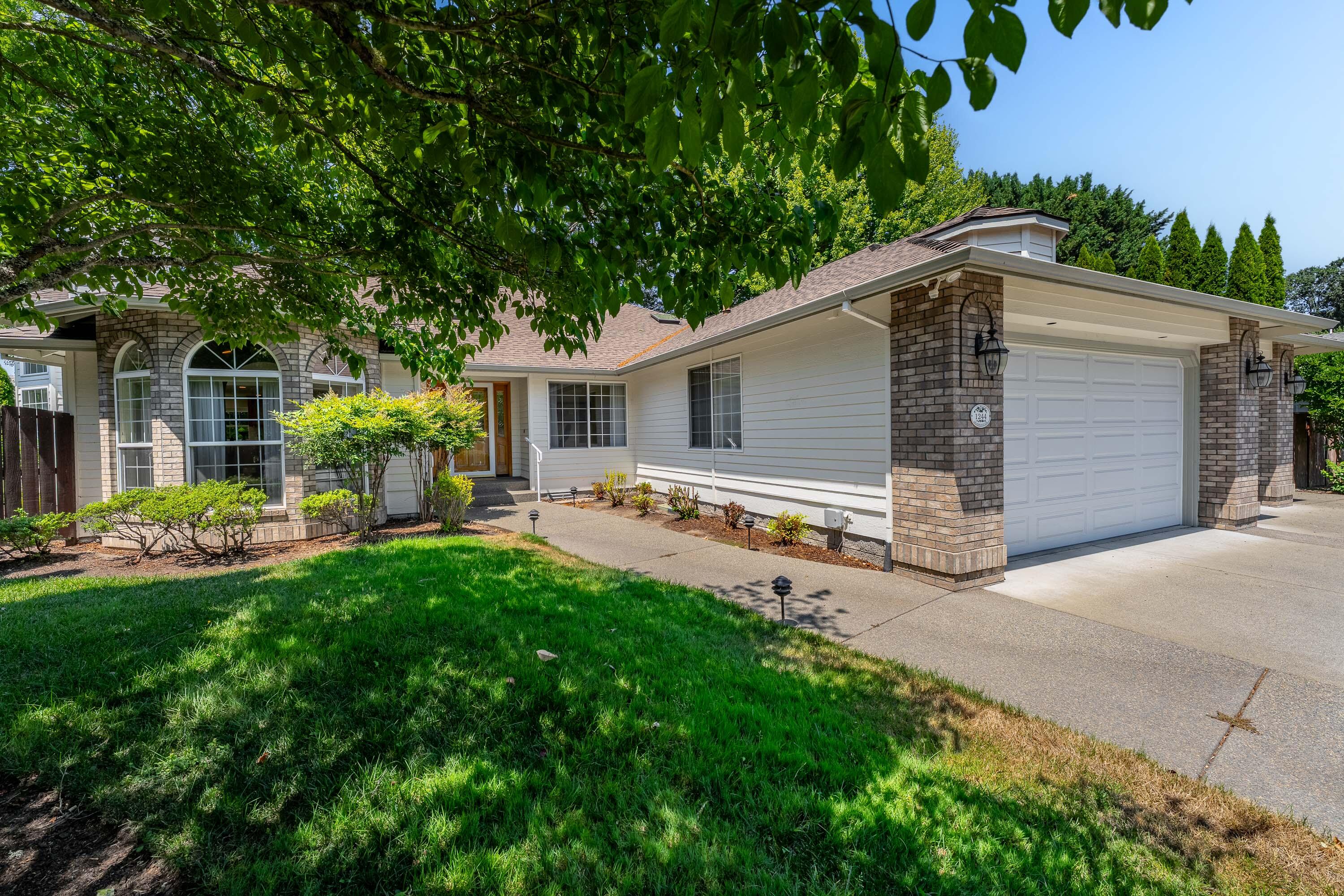 Beautifully maintained 3-bed, 2-bath home in a desirable Grants Pass neighborhood! Features include a spacious family room with gas fireplace and a remodeled kitchen with custom cabinetry and island. The private, beautifully landscaped yard with large flagstone patio is perfect for relaxing or entertaining. Enjoy deeded Rogue River access—ideal for fishing, swimming, or a peaceful picnic. Additional highlights: 3-car garage, open floor plan + 2 living spaces, vaulted ceilings, large laundry with utility sink and comes equipped with a generator. Quiet location within minutes to the historic downtown, schools, shopping, parks, medical, etc. Move-in ready and full of charm!