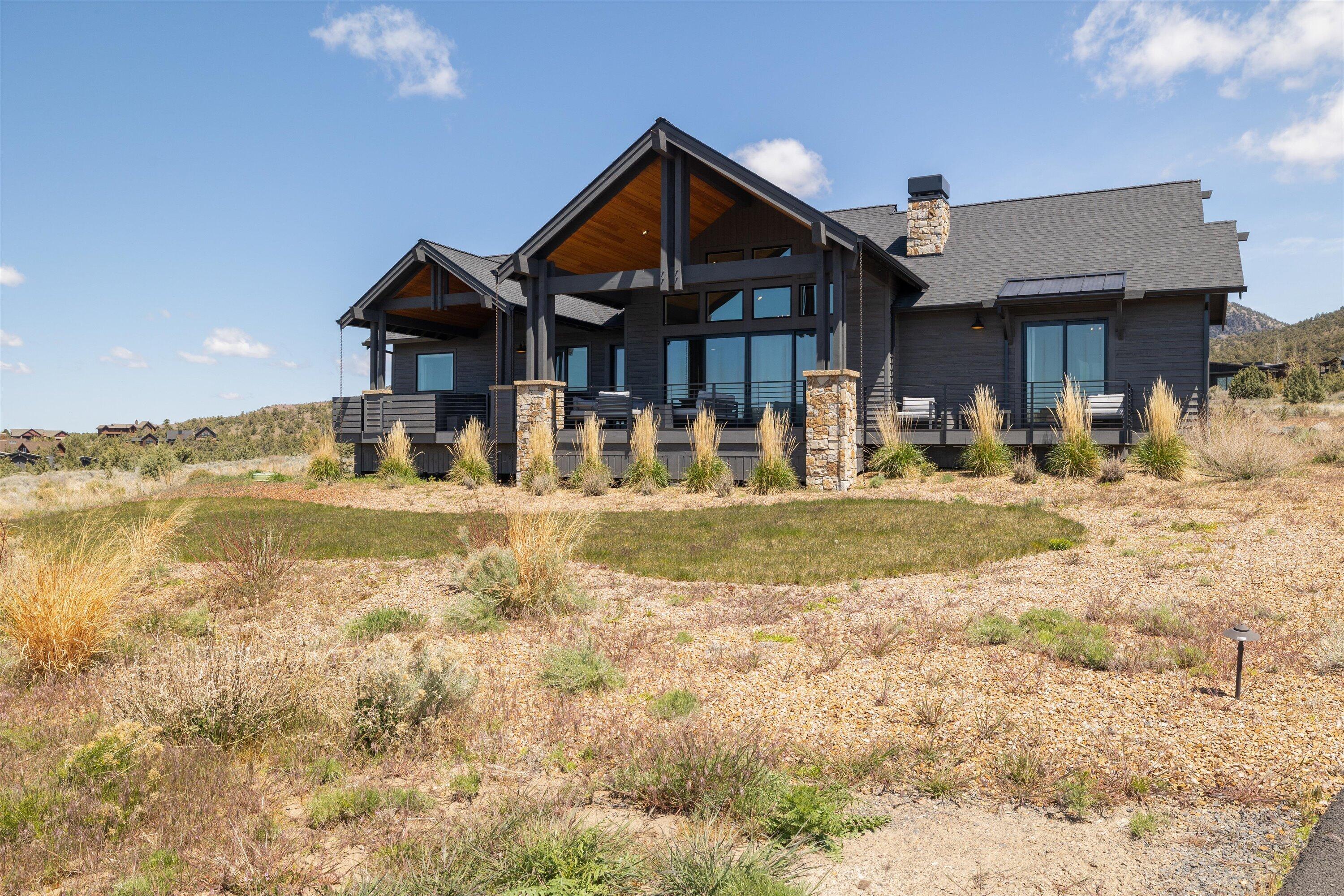 Beautiful one-level home with Cascade Mountain views and an ideal location close to amenities. The exterior features stained wood siding and extensive stone accents. This home has a commanding sense of arrival as you enter the foyer with vaulted ceilings and warmth with sunlight through the expansive windows. It is ideal for the entertainer with a large great room featuring a stone fireplace, dining room, and beautiful kitchen. The kitchen features stainless steel appliances, walk-in pantry, and a spacious island, perfect for the home chef. The primary bedroom is an oasis with a walk-in closet, soaking tub, and patio access. There is also a den ideal for an office or bedroom, two additional bedrooms, full sized bathroom and a utility room. Outside on the large deck, you can catch the sunsets while entertaining guests or relax in the hot tub. An oversized three bay garage finishes the home.