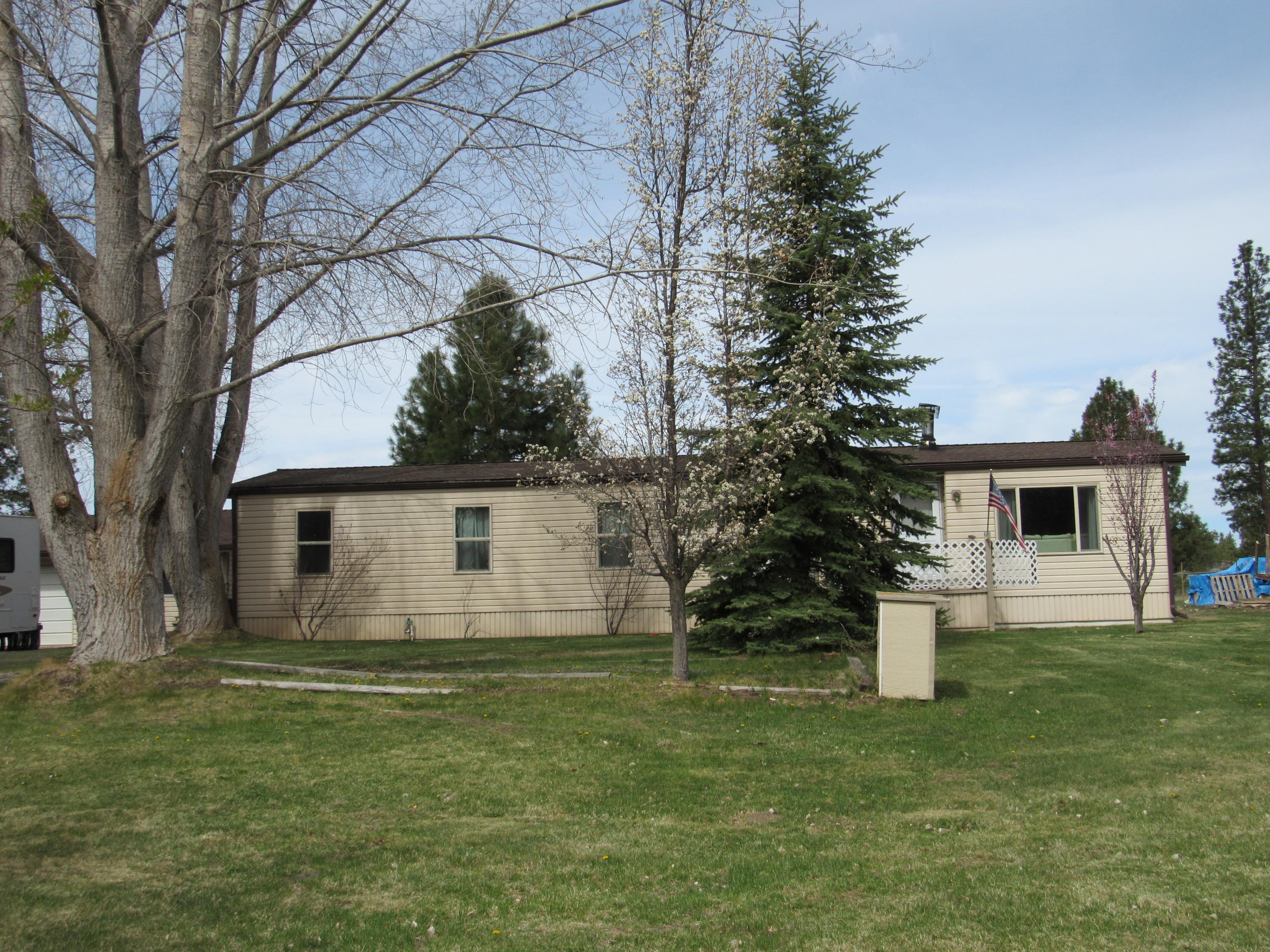 Great home in the country no subdivision, no ccrs, no association fees  all the things we look for.  All fenced  with a manufactured home and numerous out buildings included a very nice shop 48X25 with 18 ft eaves. Green house  2 car garage w/work shop. The home has been very well taken care of.Great room in the back of the home all glassed very comfortable room. could be office ,T.V. room play room, craft room you name it.  super clean property.