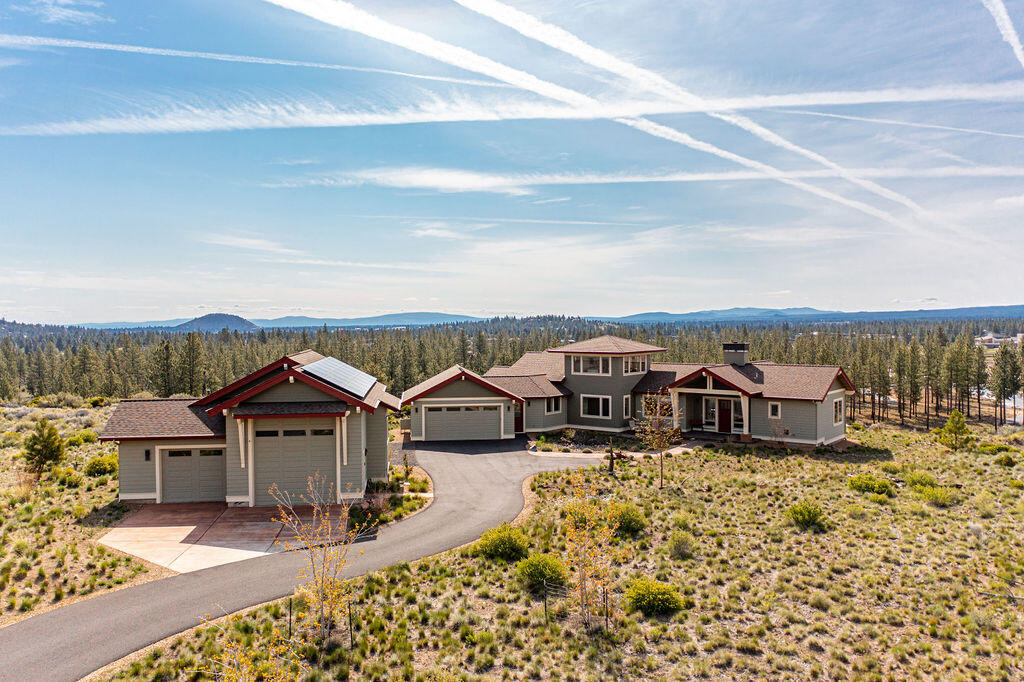 Welcome to Tree Farm, one of Bend's most sought after neighborhoods. This premier lot backs to 2 acres of open space to allow for optimal privacy. This incredible custom home greets you with large windows taking in the panoramic view from every direction. kitchen complete with granite counter tops, Hickory cabinets, two pantries and sleek tile floors. The three bedrooms are thoughtfully positioned with great separation. Primary suite complete with walk in shower, glass tile accent & rock floors. A large soaking tub looks out over the tree tops. Upstairs find the Eagle's Nest bonus room well appointed with cork flooring, wet bar, refrigerator & approximately 300 degree views. This Earth Advantage Platinum home comes with double wall construction, energy recovery ventilation, ductless heating and cooling, a tankless water heater & solar panels. Don't miss the detached 1184sf RV garage and shop that's fully insulated with heat and running water plus a RV dump.