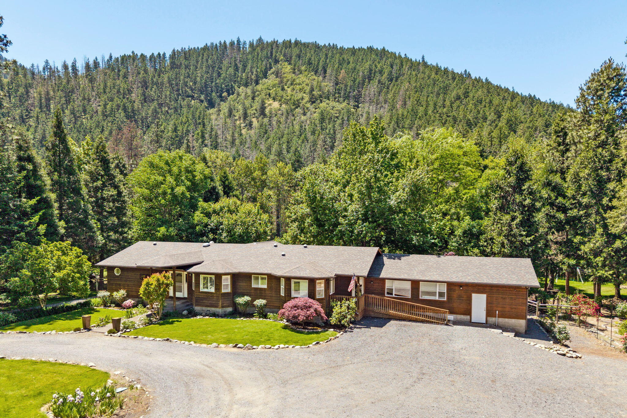 Amazing Applegate River frontage for fishing, kayaking, or tubing w/private park-like grounds to enjoy the serenity on your 3.89 Acres w/water rights from the river. Single level home w/many upgrades throughout including interior paint, exterior staining. Open Kitchen w/granite counters, DBL ovens, 5 burner gas cooktop, eating bar & Refrigerator included. Primary Bathroom w/new updates to include: tile shower, lg Walkin closet, slider to deck overlooking the river. 4-bedroom w/split floor plan, media/bonus room, hardwood floors. Separate Studio area, oversized finished & insulated 2 car garage w/ storage. New roof just added. Trees, gardens, chicken coop, hay barn, fruit trees & pasture for animals. Centrally located between Grants Pass and Medford in the middle of the Southern Oregon Wine Country.