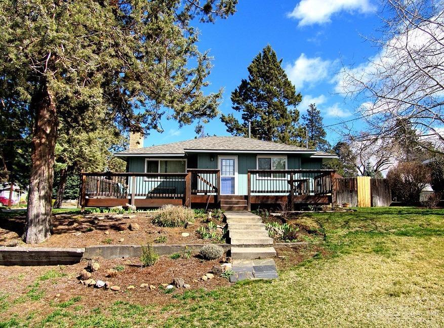 Turn key cottage on huge corner lot in Midtown. All the charm you expect including hardwood floors, wood burning fireplace, amazing yard and detached garage. This home features updates throughout: new roof, new windows, updated kitchen and bath. Huge deck where you an watch the sun set over Mount Bachelor. Oversized corner lot with fruit trees, garden area and dozens of bulbs just starting to peek up. Energy efficient updates include tankless water heater.