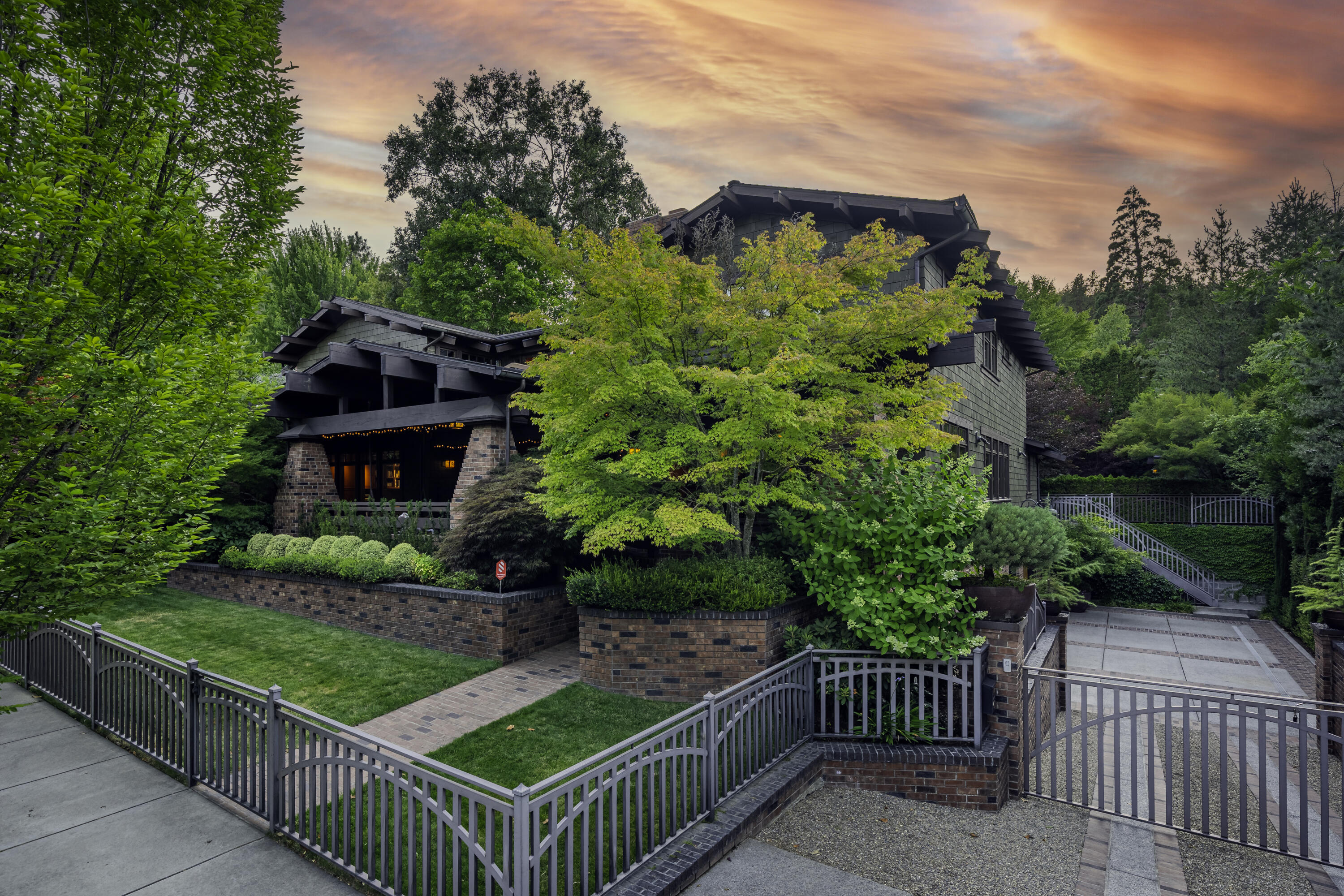 Exceptionally refined Craftsman home with unparalleled amenities - just steps from Lithia Park, and three blocks from Ashland's downtown plaza. Solid wide-plank eucalyptus floors, fir-paneled walls and ceilings, meticulous tilework, designer lighting, remote-operated shades, integrated speakers and entertainment systems, wood-burning fireplaces, and intimate gathering spaces throughout. Tranquil main-level primary with two full ensuite bathrooms, gourmet kitchen with stainless Viking appliances, butler's pantry, spacious formal and informal dining, three guest bedrooms with full ensuite bathrooms, professional-grade spa with massage shower and infrared sauna, in-home theatre with seating for twelve, game room, temperature-controlled guitar vault, two offices, and elevator serving all three levels. Mature landscaping with ornamental trees and plantings, serene outdoor living areas with radiant-heated patios and pathways, plus an in-ground lagoon pool with hot tub. Inquire for details!