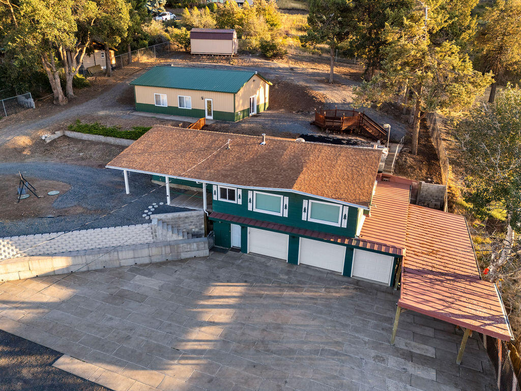 Discover your private retreat in this 3-bedroom, 2-bath home with breathtaking views of Klamath Lake and the surrounding mountains. The property includes a 3-bay garage with attached workshop/hobby room, plus extra storage spaces. A spacious 30' x 40' shop, 10' x 20' storage shed, and covered carport provide endless options for projects, hobbies, and toys. The gated driveway with keypad entry ensures both security and convenience, with ample parking for larger vehicles, RV'S (30 amp service in driveway) or guests. Offering privacy, functionality, and views, this home is the perfect balance of comfort and tranquility.