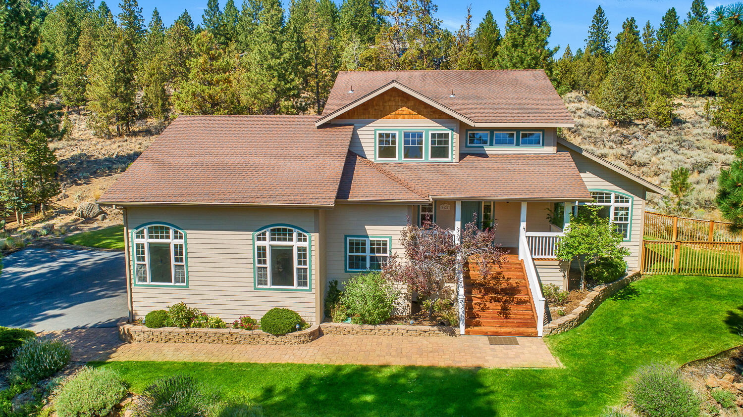 This beautiful Aubrey Butte home is nestled on a private and sunny half acre lot in the City View neighborhood.  Built in 1997, this nearly 2500 square foot home is perched for capturing the natural sunlight.  Main level with solid maple flooring, formal and informal living areas and primary suite. The kitchen has been modernized with slab countertops and updated appliances. The second level has three bedrooms, a large bathroom, and a potential pass-through addition above the garage to add a future bonus room.  Take in the sunset and city lights from the large front porch, or relax in the shade on the back deck off the kitchen. 800 square foot two-car garage with large shop area. New furnace in 2018.  Mature low-maintenance landscaping around the home as well as wide open areas with gorgeous rock outcroppings.  Just minutes to downtown Bend!