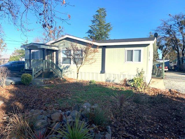 Great Opportunity!!! 2 homes close to town with that country feeling and taxes. Could be used as a two-family set-up. Endless possibilities! The stick built house features 3 Bdrs, 2 Bths, 1192 SF, living room, large family room, kitchen with breakfast bar, split bedroom floor plan, inside laundry, covered deck & a carport. There is also a small workshop. The manufactured home has 3 bedrooms, 2 baths, 1186 SF, built in 2002, open floor plan, kitchen with island and dining area that opens to the great room, split bedrooms, master on one side and two bedrooms on the other side. There is also a darling playhouse with a swing set for the kids, 2 storage sheds, plenty of space for a garden plus room to park all your Bigz Boyz Toyz on this level useable .94 of an acre. There is a poured concrete pad for an RV with hook-ups in the back of the property. This home appraised at $350,000. Appraisal is on file (appraised October 2019). This is a must tour home.