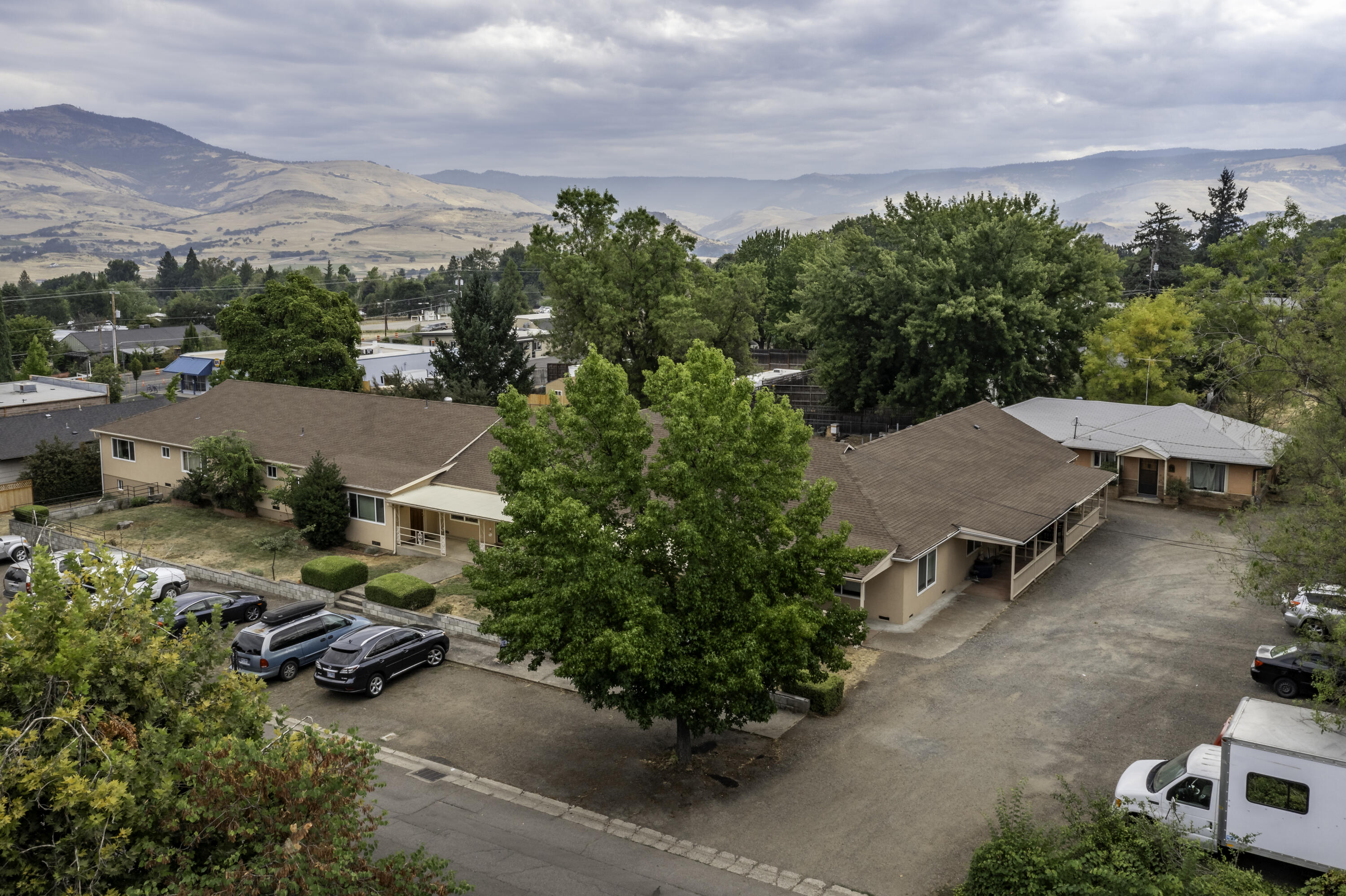 Rare Offering! Single level 12 plex Ashland property on large & level, 1.2-acre parcel with room for additional development. Great location near SOU, YMCA, shopping, restaurants & bus line. Well maintained with many upgrades. Attractive interiors for these uniquely sized apartments which include studios, 1-, 2- & 3-bedroom units plus a detached 3-bedroom house. Nice expansive outdoor spaces with covered porches, 3 large, covered patios, lawn area, views of the mountains. Two large parking areas. Separate fenced area for development for a possible 5 additional units. Please do own due diligence with City. Recent upgrades include plumbing, electrical, all new appliances in unit 7 including mini-split HVAC. New color-in stucco on main building, over 40 new double-glazed argon-gas vinyl windows, recent paint. Many previous upgrades include cabinets, flooring & appliances. Financials provided with signed Non-Disclosure. Possible owner-carry with large down.