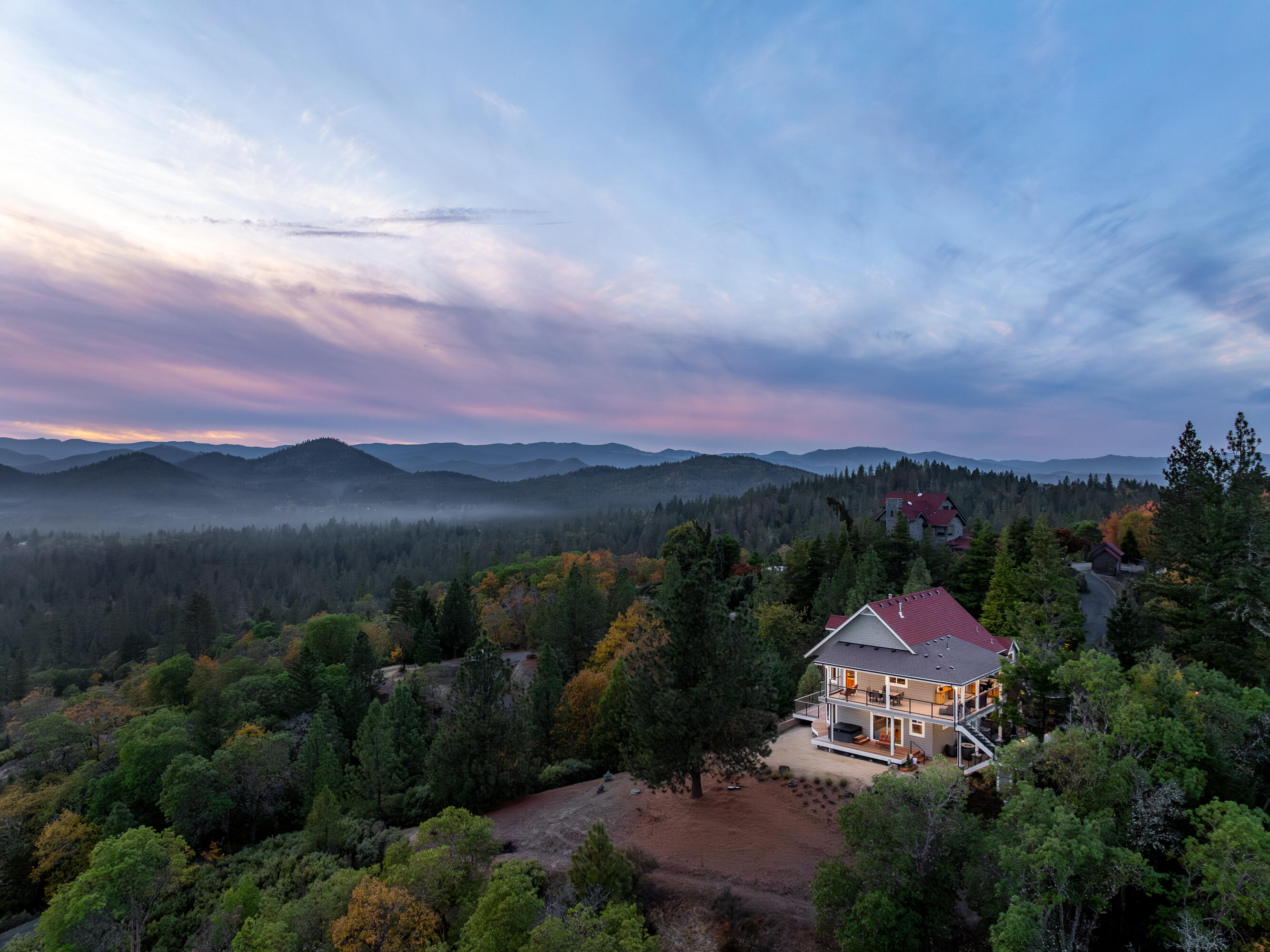 This stunning property offers a serene retreat w/exquisite living spaces & custom amenities w/awe-inspiring vws. Evenings come alive under a canopy of star-filled skies, creating a magical setting. Gated, paved drive escorts you to this private mtn estate. This home is timelessly designed for prime entertaining. Where Typical is replaced by fine Craftsmanship in all details that award this artful 2 story, 3 bdm (primary & spa suite downstairs), 4 ba hm. Amazing wood ceilings greet you to an open floorplan that seamlessly connects the LR, dining area & to the dream kitchen that will awaken your culinary senses w/chef's quality stainless-steel appl & a unique island. You'll want to spend hours on the open covered balcony w/an outdoor kitchen that surrounds the south upper level. Take the inviting staircase & descend to the courtyard-fountain area to a covered patio surrounded by the beautiful landscape. All this, just min to S Grants Pass amenities & the Applegate Valley Wine Country.