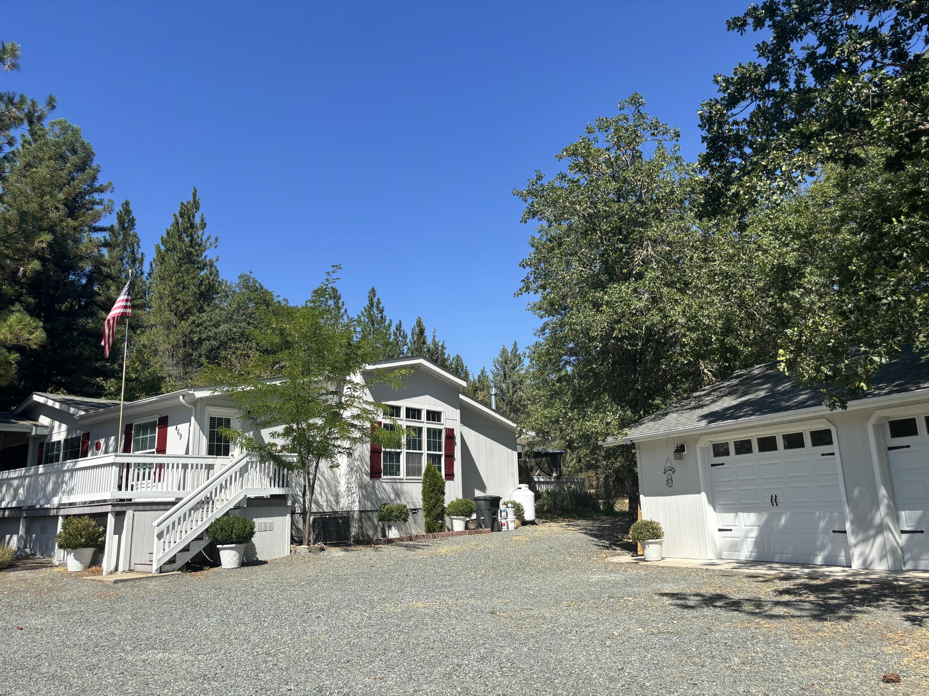 Seller offering $5,000 towards buyer's prepaids and closing costs!  Beautifully maintained 4 bed, 3 bath, 2,786 sq ft Triple-Wide home built in 2006 offering a great layout, 10 ft vaulted ceilings, granite countertops, open kitchen with center island with a dining bar, walk-in pantry, a sunny breakfast nook and a formal dining room. Engineered wood floors and custom blinds throughout, den with gas fireplace, large living room, a spacious master suite with walk-in closet with private patio access. En-suite has double vanity, jetted tub and tile shower. The other 3 bedrooms are on the same level. Step outside onto a huge 900 sq ft trex deck with an outside fireplace and gazebo, plus 100 sq ft hot tub space and a 10'x40' awning. A tiered waterfall and a pond with goldfish awaits you for those serene nights sitting on your deck relaxing! Enjoy almost one acre of manicured landscaping and an oversized two car garage. 30 AMP service for your RV if needed and a fully fenced, private backyard