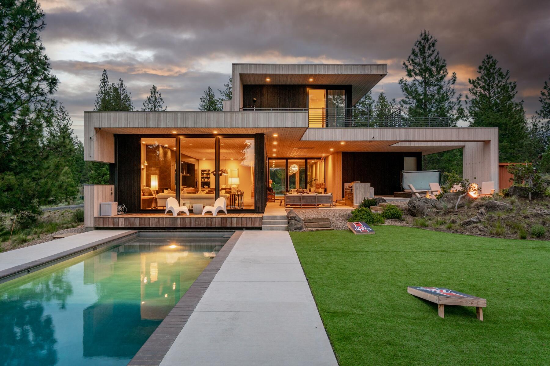 Modern luxury designed in collaboration by Meglasson Architect + Lightfoot Architecture and built by CS Construction. Situated on 10.5 wooded acres with a perfectly framed view of Broken Top, this 3,478 sf 3 bedroom, 3.5 bath home with a loft and primary suite wing that includes an office and fitness room. Stunning inside and out with two toned cedar finishes, large windows to soak in natural light, oak floors, custom cabinetry, and much more. Kitchen features include a large island, double ovens, dry bar, ice maker, and large pantry. An entertainer's delight with a great room that flows out to the covered and heated outdoor dining and sitting area. Outdoor features include a built in BBQ, hot tub, heated pool with electric cover, gas firepit, dog run and roof top patio. Located on Bend's westside in the gated Highland's at Broken Top neighborhood and backing to forest land w/access to Phil's Trail. This is a very special Bend property with incredible attention to detail throughout.