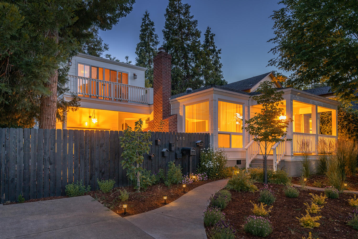 Exactly where you want to live—located in Ashland's sought-after ''golden triangle,'' near downtown theaters, restaurants, the Food Cooperative, trails, and 100 acres of Lithia Park. Well-maintained home features single-story living with two bedrooms & one bathroom, hardwood floors, a spacious living room, windows framing views of Grizzly Peak, a thermostat gas fireplace, numerous built-ins, a family kitchen, & dining area. From the exterior stairwell you'll find the studio with a balcony and full bathroom — ideal as a separate residence with rental income potential. Off-street parking, a gated courtyard beneath a majestic cedar tree — plus there's a second covered patio surrounded by greenery. Recently enhanced with foundation work, fencing, paint, sewer lateral, HVAC scrubber, & more. Greenhouse is included, there is wiring for a hot tub at the garden shed. Architectural landscaping with espalier apple and pear trees, bay laurels, peonies, & established conifers — a dream come true.