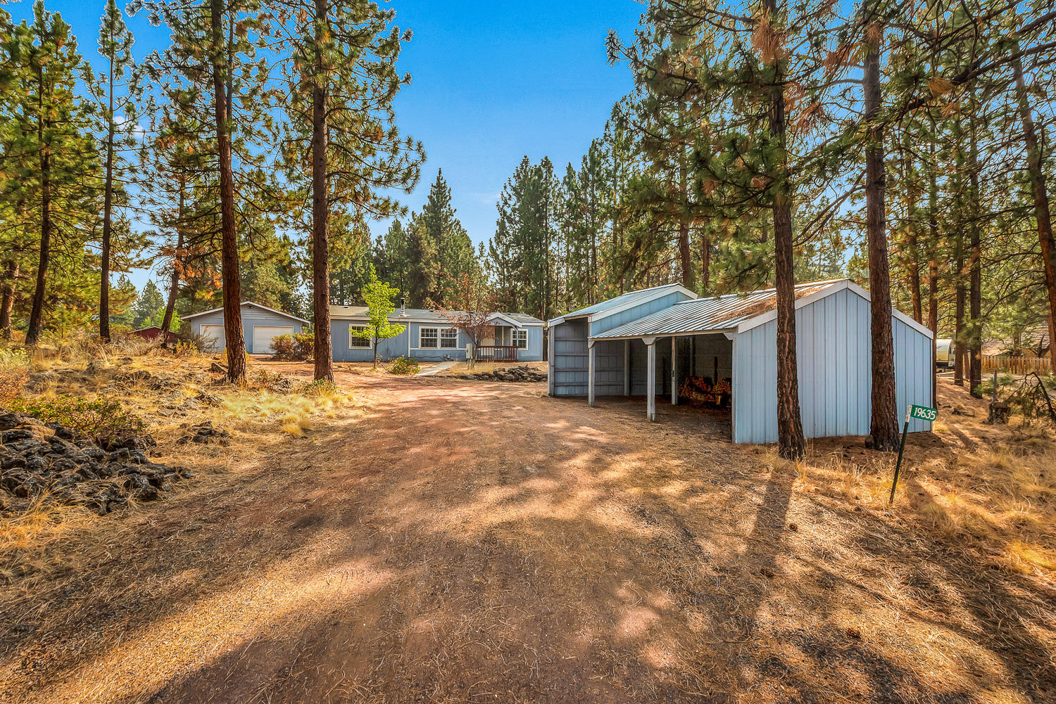 Nestled in the trees on a quiet street, you will find this spacious light and bright home on a half acre.  This handyman's dream features a wood stove in the living room, a primary suite with a walk-in closet, plus two bedrooms and a bathroom on the opposite end of the home.  In addition, you won't want to miss the detached finished and heated double-car garage with a 12x24 shed with separate entrance attached to the back.  The property also features a 720 sq. ft. machine shed with 3 extra covered parking spots for all of your toys.  This is a must see!