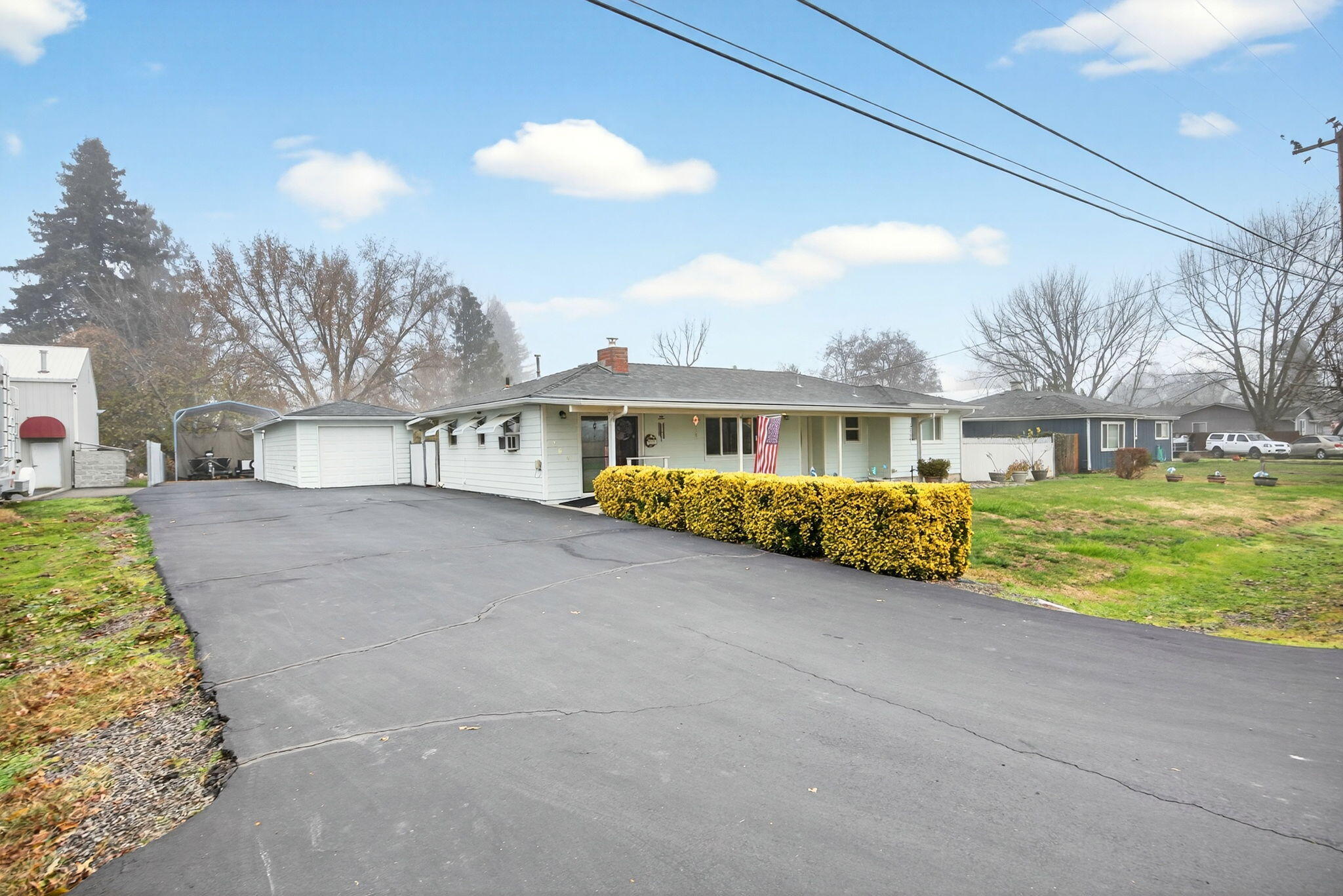 Beautifully maintained 1958 single-level home with many updates. Features a 3 bed/2 bath open floor plan plus a versatile office/den/bonus room, previously used as a beauty salon. Zoned General Industrial—ideal for a home-based business with multiple options. Nearly 0.40-acre level lot with a large gated and paved RV parking area, garage and shop, and a spacious RV port at the rear. Enjoy the 350 sq. ft. covered front porch, rear patio, and fully fenced yard with room for a garden or pool. Interior updates include newer kitchen cabinets and countertops, a large pantry, updated bathrooms, a fireplace with wood-burning stove, new roof, new vinyl windows, and new slider doors. Equipped with central heating and A/C. Property also includes an unused well (7 GPM when drilled).