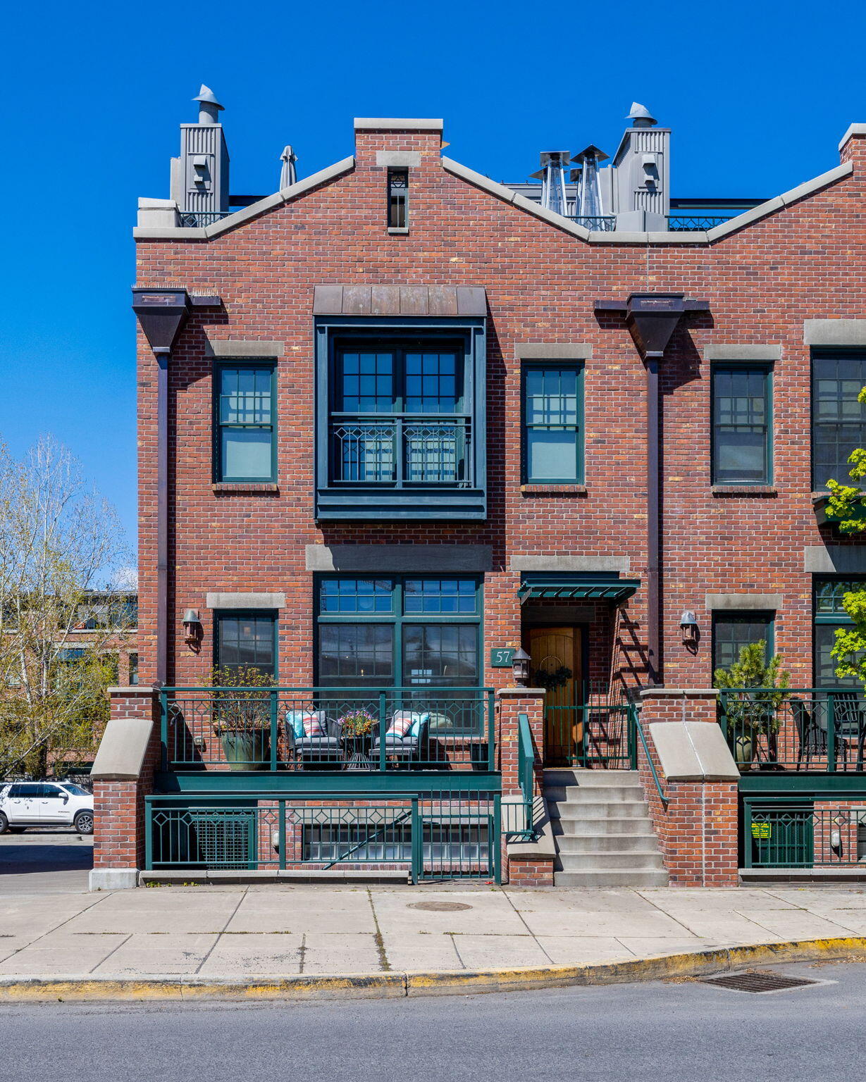Rare Opportunity in the Mill Quarter! Gorgeous 3721sf Industrial Style Brownstone Townhome in the heart of Bend's vibrant urban scene. Situated in the coveted Mill Quarter, this location provides immediate access to Downtown, Box Factory, Old Mill District, the Deschutes River and trails. Enjoy captivating views of the Cascade Mountains and Pilot Butte, while entertaining your guests on the private rooftop Terrace. Main level boasts a spacious open living area merging seamlessly with a gourmet kitchen equipped with Viking appliances, a beautiful dining area, a 2nd family room and terrace. Primary suite features walk-in closet, luxurious soaking tub, tiled double shower & French doors opening to a charming terrace. The downstairs suite w/private entry can serve as a guest suite, home office, art studio, separate living quarters or whatever fits your needs. Elevator gives easy accessibility to all levels. No HOA fees. Come see it today!