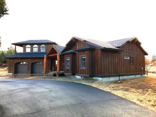 Hard to find large home on 2 acres that is located just off Powell Butte Hwy, this property is tucked at the end of a private lane. High vaulted ceilings with exposed wood beams, hardwood floors, open and light concept, large master bedroom suite, a partially completed bonus room above garage and more.