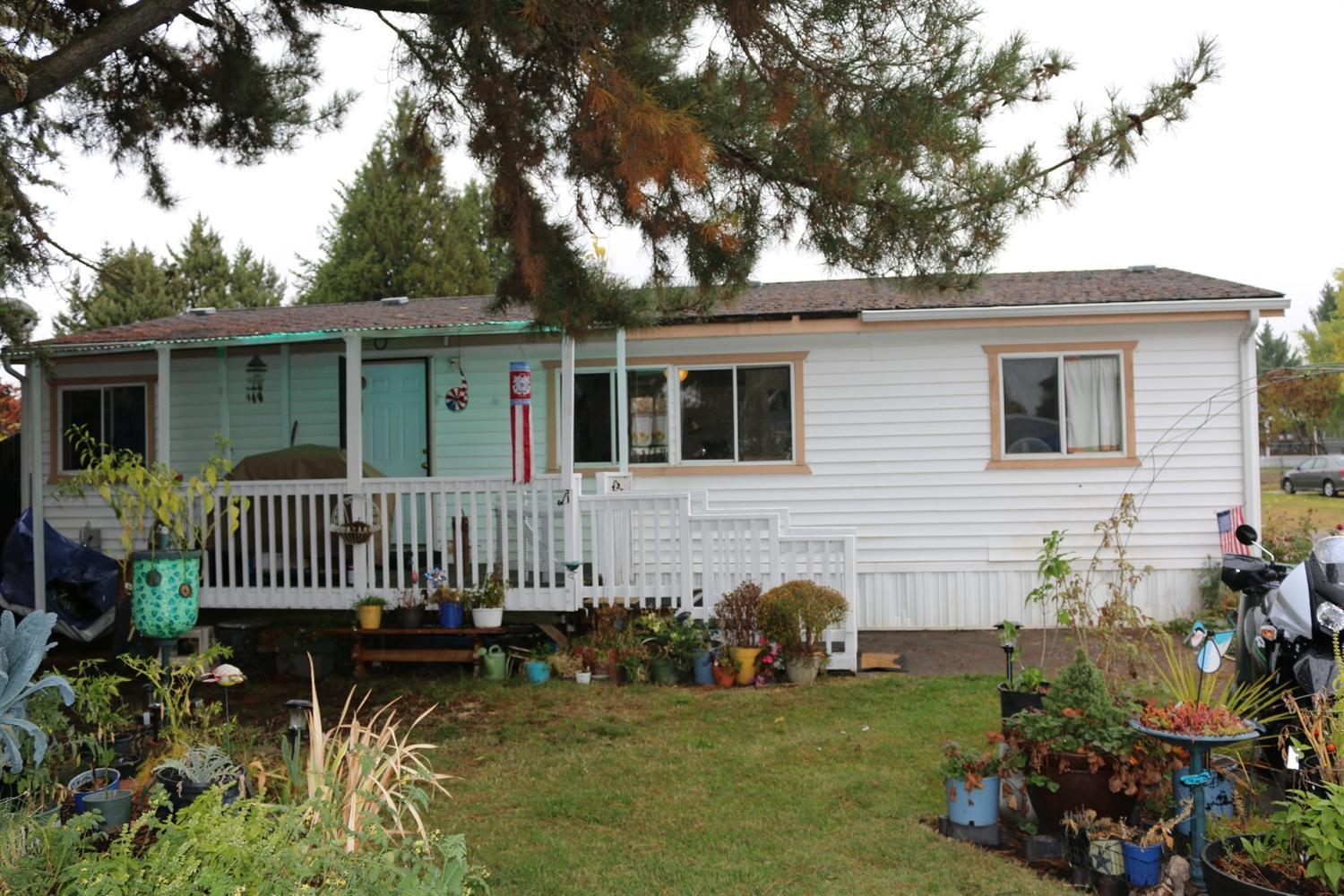 Conveniently located & affordable 3 bed/ 2 bath move in ready manufactured home in quiet cul-de-sac in Aloha Sun Mobile Estates. Home has split floor plan with many upgrades which include new flooring, new interior paint and much more. Plenty of room in front yard for gardening with mature trees provide plenty of shade for hot summer days. Large covered front porch/patio provides ample space for BBQ's with friends and family. Property sold as-is. Park rent includes water, sewer, and garbage/recycling. Clubhouse and gated & locked trailer/RV parking available by reservation. Buyer must be approved by park management.