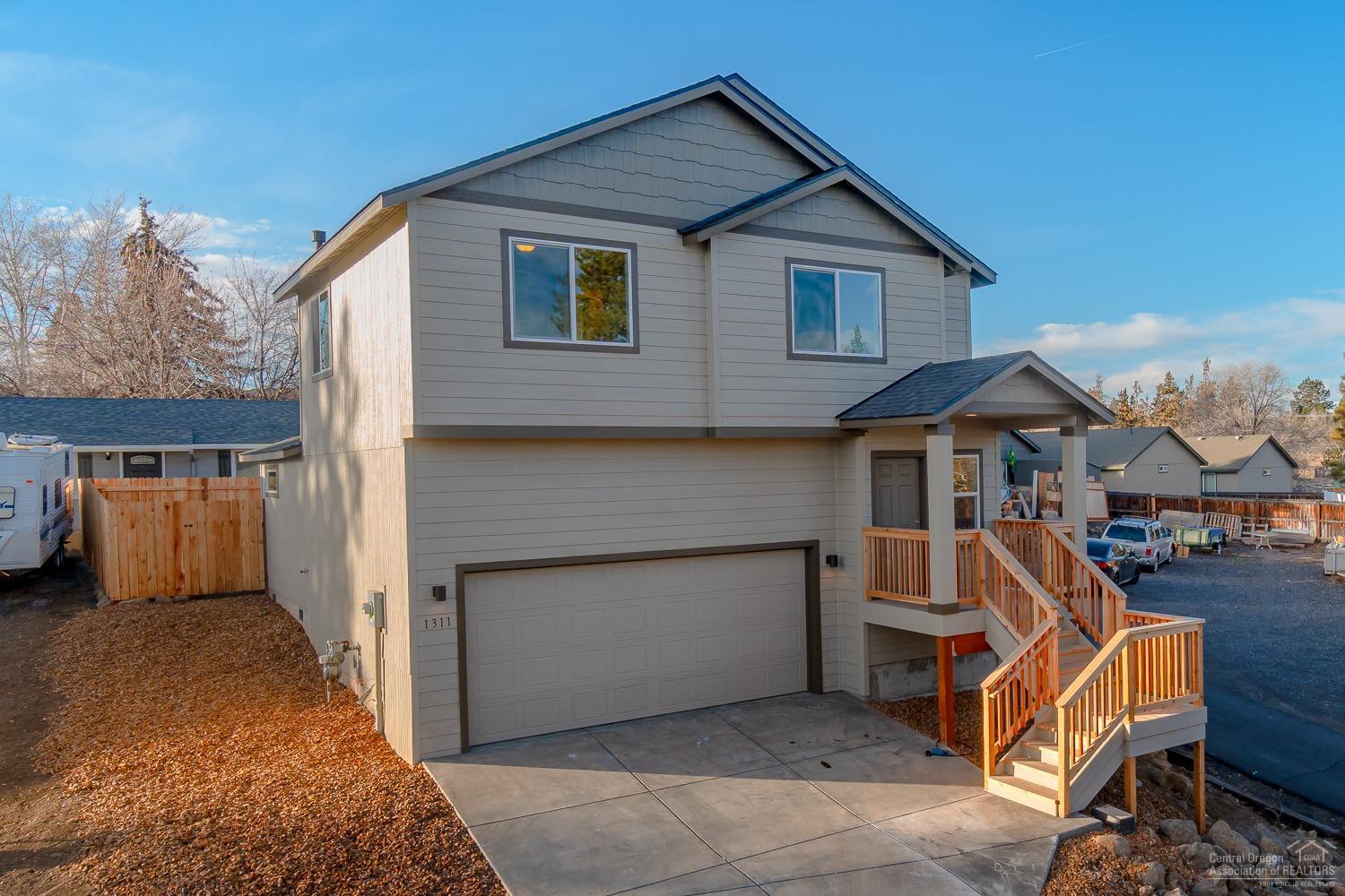 Now complete & move in ready! Perched above the road w/2nd story views, this efficiently designed two story home boasts a vaulted great room, open kitchen w/tons of cabinet space & breakfast bar island. Great room plan is perfect for entertaining & extends outside to the fenced back yard & patio area. All three bedrooms & laundry fit comfortably upstairs to complete this floor plan. Wide plank Laminate wood floors in main living spaces, modern Quartz slab counter tops, Espresso toned cabinetry w/stylish brushed nickel hardware. Stainless Steel appliances & designer paint scheme - this home is ready for you to move right in! Super tall double car garage, pre wired for A/C, gas forced air heat & low maintenance landscaping. Back yard is fully fenced with side gates, beautiful rock zeroscape in the front, paved drive & concrete parking areas. Don't miss!<br>