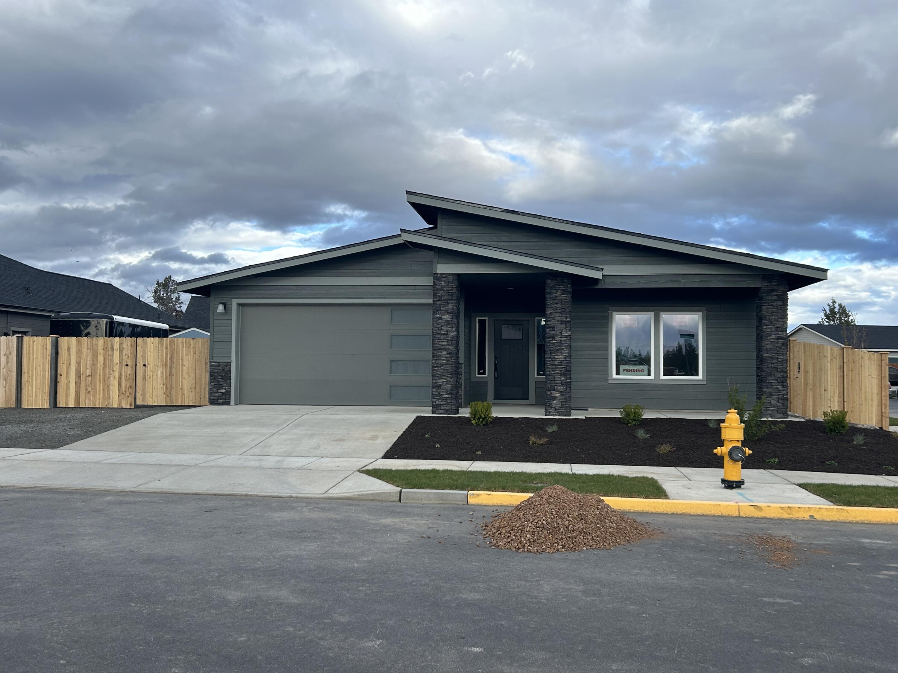 Welcome to Korbin Meadows, a new community in desirable neighborhood of SW Redmond. Lot 13 features the Juniper floorplan w/ single level living; 3 bdrms, 2 baths, 2 car garage & spacious side yard for RV/boat parking. Cascade mtn views from the covered front porch and front bedroom window.  Entertain in your kitchen w/ SS appliances, walk-in pantry, tiled backsplash, soft-close cabinets, extensive slab quartz countertops & large island opening to dining area and vaulted great room w/ decorative gas burning fireplace. Primary bdrm features a walk-in closet, dual vanity w/ shower. Two guest bedrooms share a full bath with double vanity. Utility/laundry room too! Durable laminate plank flooring thru-out & carpeted bdrms. Corner lot w/ fenced yard & landscaping w/ sprinklers & entrance gate. Upgraded finishes & A/C included! Est. completion April 2024. *Floorplan & rendering subject to change.