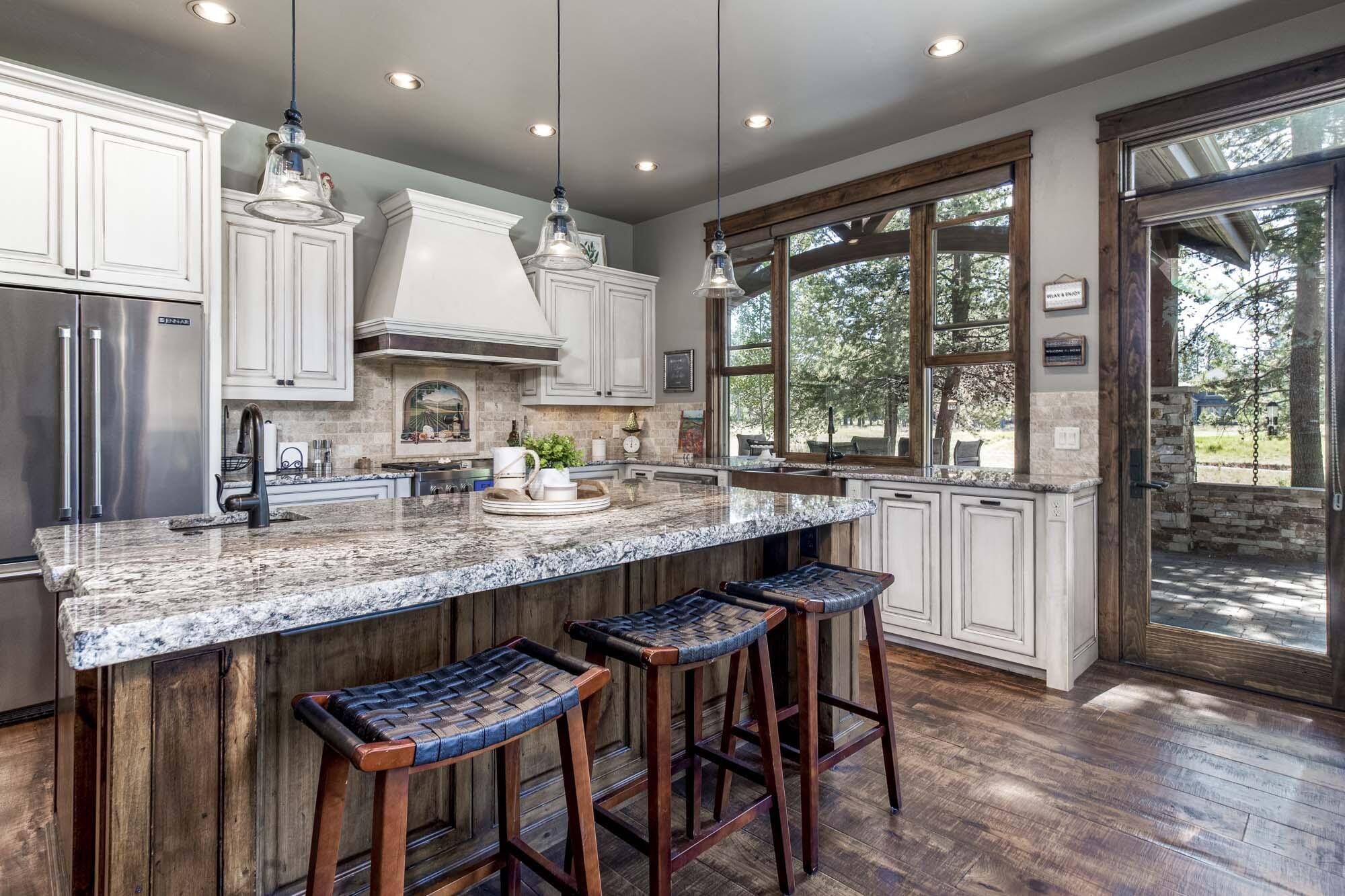 Custom High Timber Construction built home w/ golf course views! High end finishes throughout. Gourmet kitchen includes granite counters, copper sink, gas range, warming drawer and Miele coffee station. Great room has stunning beams w/ metal brackets, wood burning fireplace w/ floor to ceiling stone, hardwood floors & vaulted wood ceiling. 3 suites w/ private baths, a bunk room w/ private bath plus a large bonus room w/ wood ceilings, a wet bar for entertaining and deck. Primary suite includes gas fireplace, wood floors, wood ceiling, large walk in closet w/ optional lock off, heated floors and soaking tub. Enclosed courtyard overlooking the golf course w/ built in BBQ, granite counter w/ passthrough to kitchen, gas fireplace, paver patio, hot tub & fire pit. Spacious mud/laundry room w/ sink, 1 washer & 2 dryers. 3-car garage w/ built in cabinets, storage room & 3rd bay lock off. Zoned heating, A/C, wood windows, central vac, new exterior paint, sold furnished.