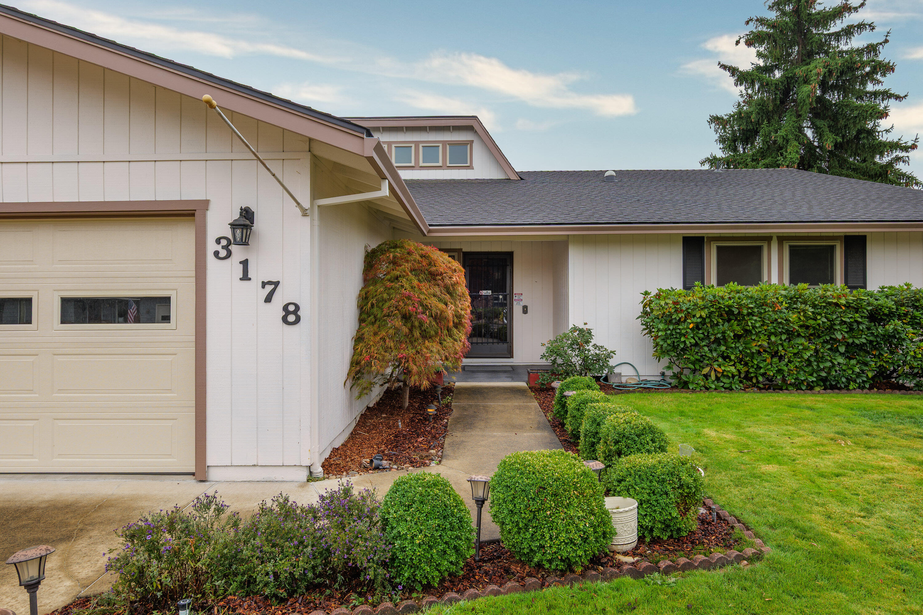 Fantastic East Medford location close to medical, shopping, and schools! This spacious 3-bedroom, 2-bathroom home sits on a large lot and includes a rare find — a 660 SF shop right in the heart of town. The kitchen features a breakfast bar that opens to a cozy living room with a fireplace, flowing seamlessly into the formal dining area and a second spacious living room. For plant lovers, the light-filled atrium is the perfect space to nurture your indoor garden. The primary suite offers two closets and dual sinks, with two additional bedrooms and a guest bath nearby. Step outside to a huge covered patio spanning the length of the home — ideal for entertaining — and a generous backyard with plenty of room to play, garden, or simply relax.