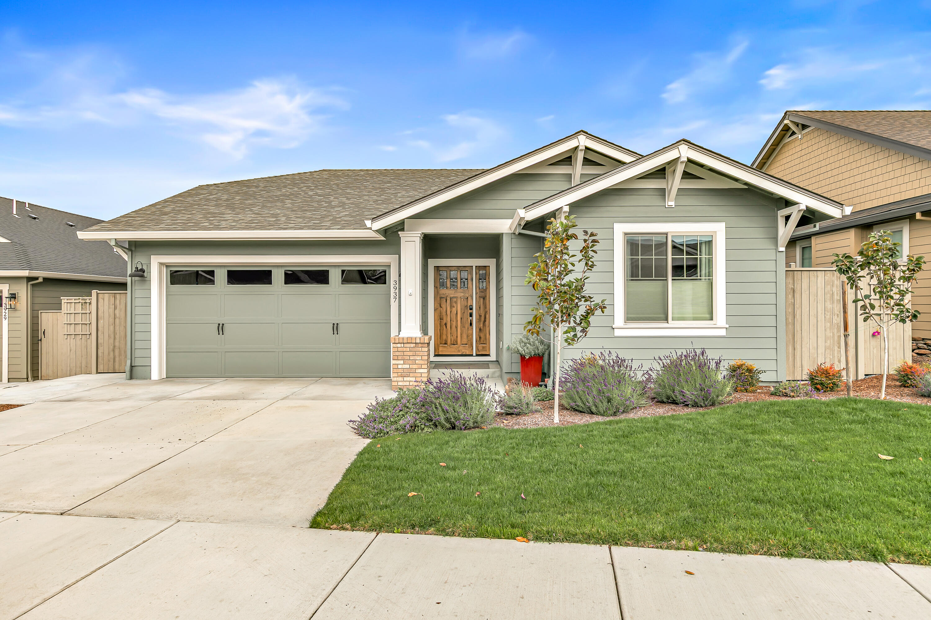 Find modern comfort and timeless style with this Craftsman-style 2023-built, Earth Advantage Certified home built by the prestigious Mahar Homes. Virtually new construction, this meticulously maintained open floor plan residence showcases quality craftsmanship and elegant design throughout. Enjoy beautiful engineered hardwood floors, a cozy gas fireplace, a chef's kitchen featuring quartz countertops and stainless steel appliances. The spacious primary suite offers a serene retreat with a luxurious tile walk-in shower and generous closet space. Outside, the owners' thoughtful landscaping creates an elegant and welcoming yard that perfectly complements the home's curb appeal. Combining energy efficiency, modern finishes, and a prime location, this home offers the best of East Medford living.