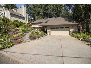 Tucked into a tranquil Portland neighborhood near a peaceful creek, this contemporary 3-bed, 2-bath home sits on a lush 0.34-acre corner lot. The open floor plan features hardwood floors, a cozy gas fireplace, and abundant natural light from skylights and expansive windows. The main-level primary suite offers privacy, while central A/C and central-vac add comfort. A partially covered deck overlooks mature trees, beautiful flowers and are watered by sprinklers. With a 2-car garage, ample storage throughout, and potential for additional bedrooms, this home blends style, space, and versatility.
