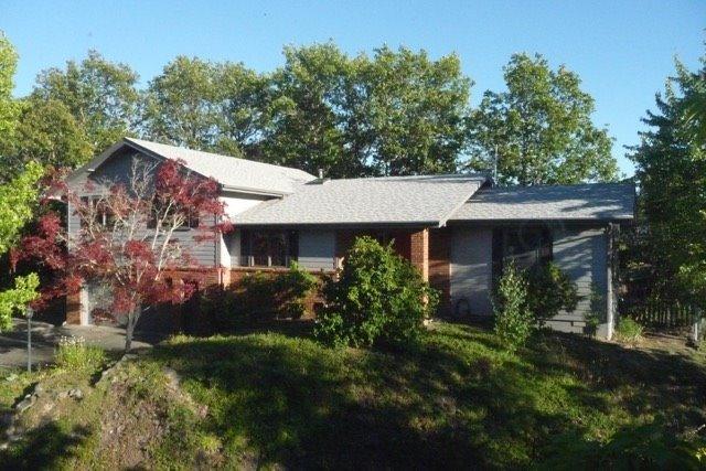 This is a gorgeous one owner home on top of a knoll in North West Grants Pass. It was designed by the owner and is very custom built with superior materials. It has four bedrooms and two bath rooms with 1980 square feet of living space. It is a tri-level, Has real Oak flooring thru out except for the bedroom. Tile flooring in the utility room. The windows are Anderson wood windows which are clad on the exterior for no maintenance. It has a newer high efficiency natural gas furnace and a high efficiency natural gas stove in the living room. The garage is huge, you can park two cars in it and have a large work shop also, it measures 35 feet long and 22 feet wide inside. Has a very nice deck that can be accessed from the dining room and the master bedroom. Comes with all of the appliances. Has a newer, heavy architectural composition roof, and has been recently professionally painted. All information deemed accurate but subject to change.