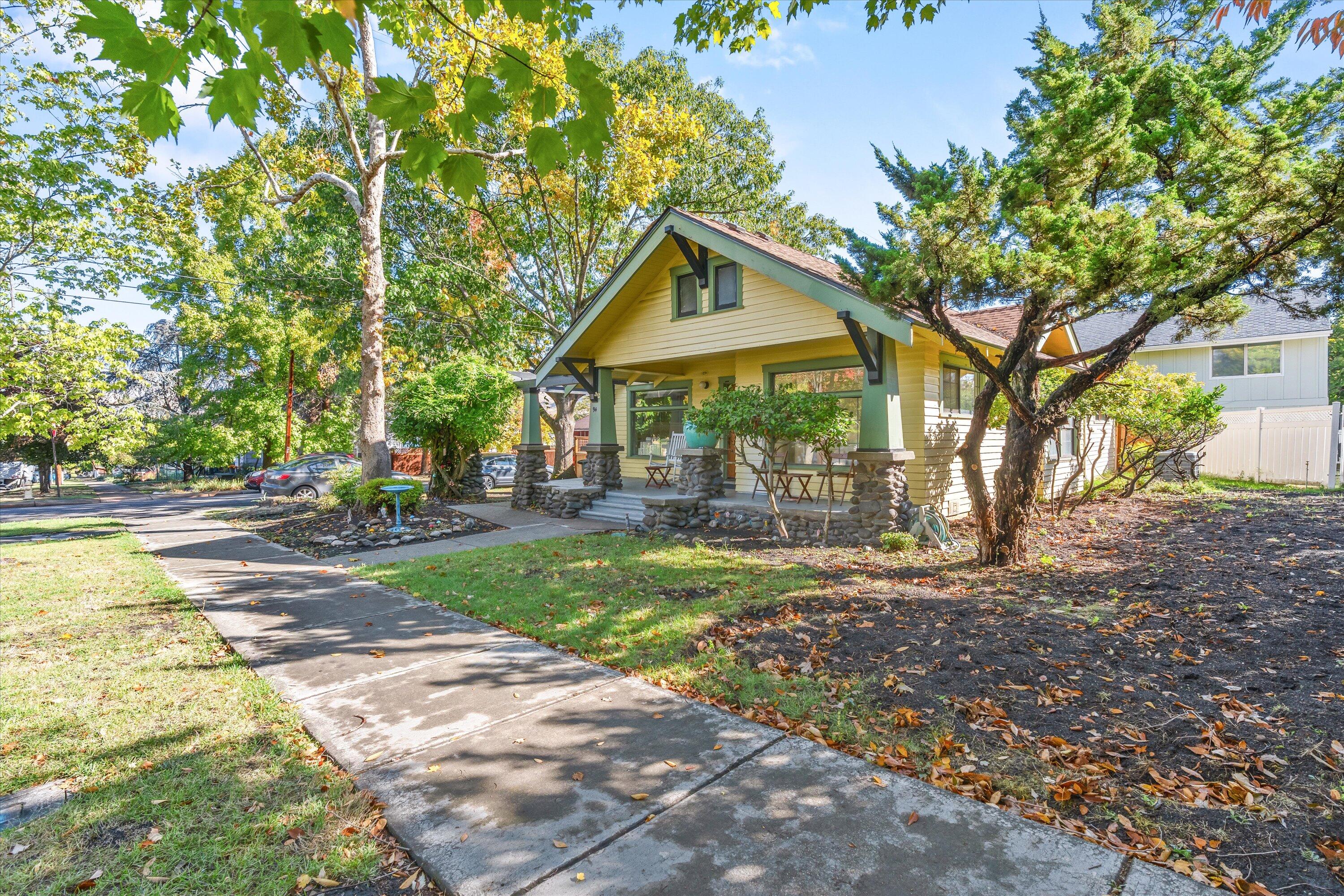 Fantastic downtown Ashland location with curb appeal!  This 2- bedroom, w/den-office & one bath, home is cozy and provides ample room for storage and living space. Enjoy sitting on the deck in the mornings with mountain views!
Owner has invested in the last year in a brand-new beautiful deck along the home, new gates and fencing, FP insert, newer HVAC system and all brand new ductwork and insulation making this home very energy efficient and new sprinklers. Recent upgrades include new electrical panel, flooring in many of the rooms, new interior paint throughout and a new roof in 2022. This 1920's vintage Craftsman home is located in Ashland's famous Historic District and just a few minutes' walk to the plaza. You will find shopping, fine dining, the Oregon Shakespeare Festival, Oregon Cabaret Theatre, & Lithia Park all easily accessible. There is a liability insurance fee for the small HOA ($190/annually) that also provides 2 parking spaces towards back of the property